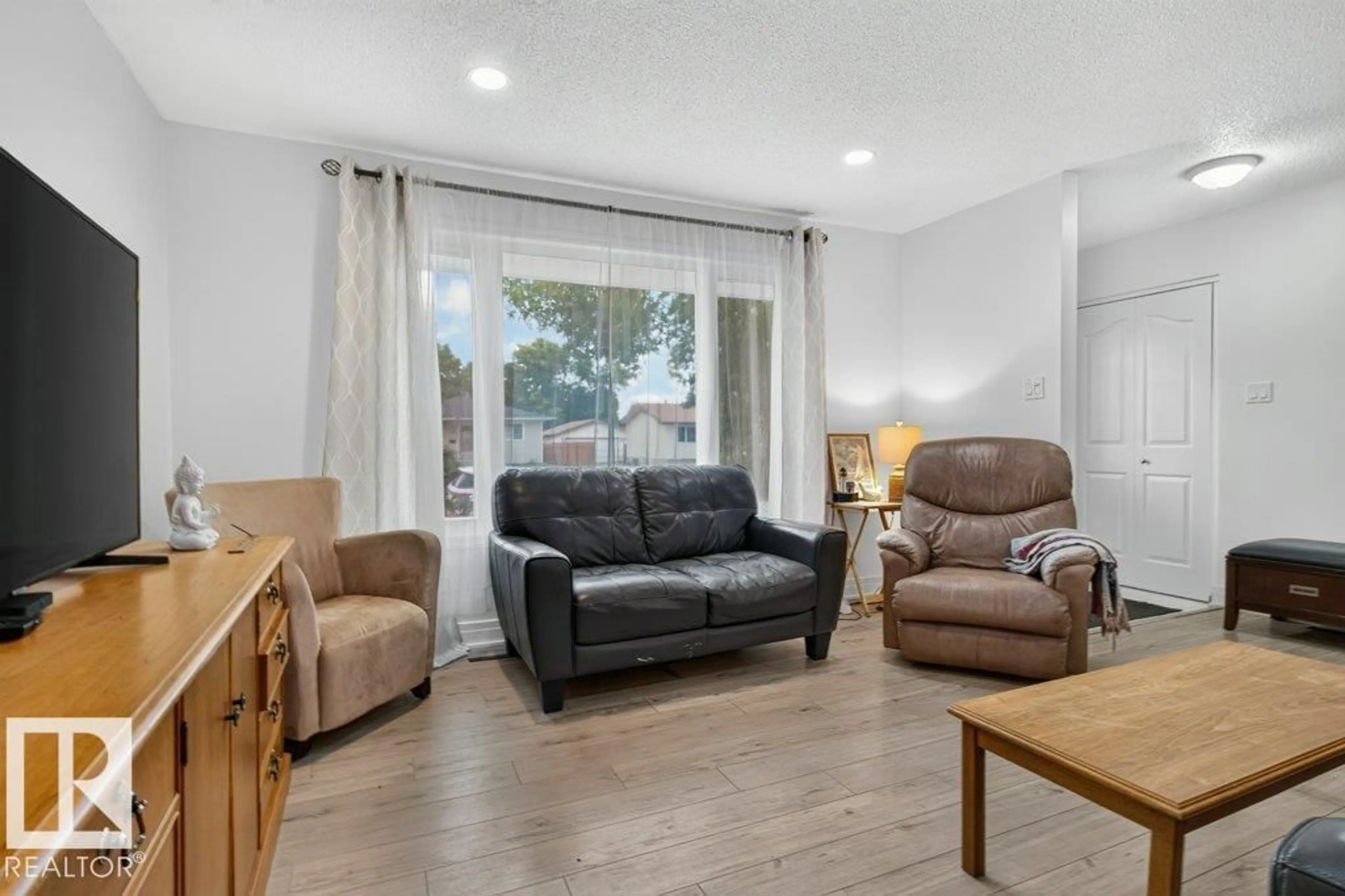 Living room with furniture, wood/laminate floor for 17 STARLING DR, Sherwood Park Alberta T8A0A6
