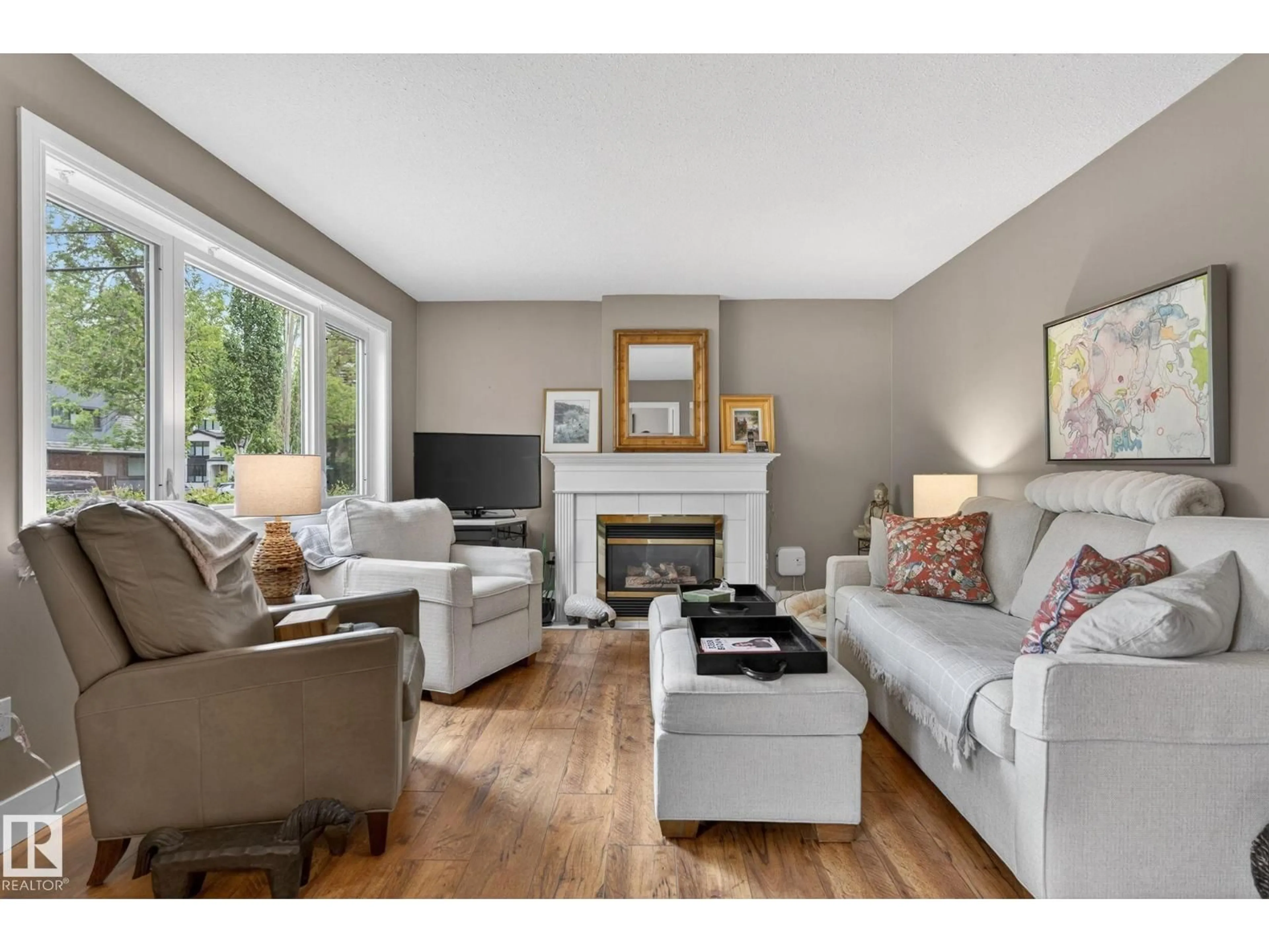 Living room with furniture, wood/laminate floor for NW - 10108 144 ST, Edmonton Alberta T5N2T7