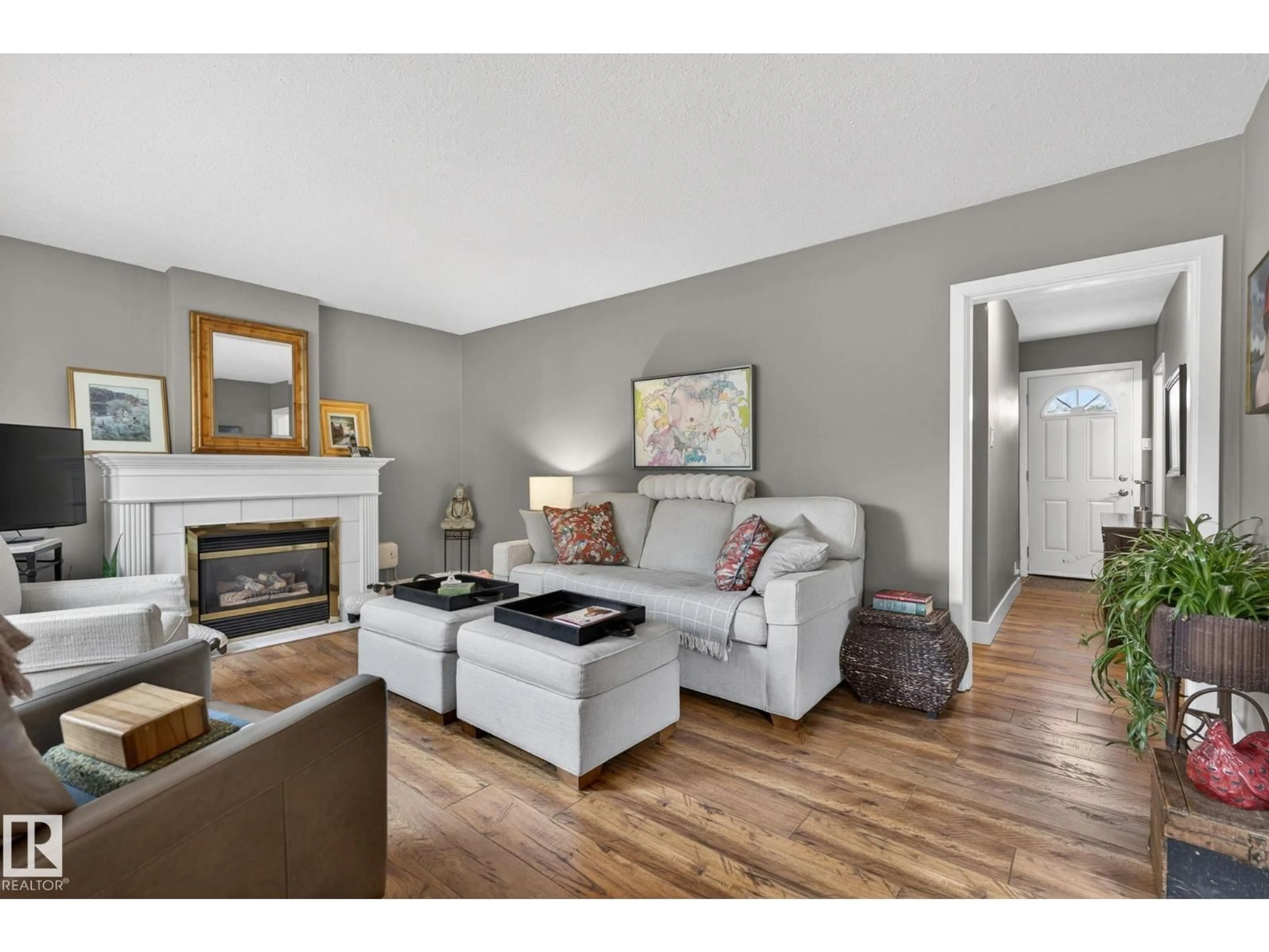 Living room with furniture, wood/laminate floor for NW - 10108 144 ST, Edmonton Alberta T5N2T7