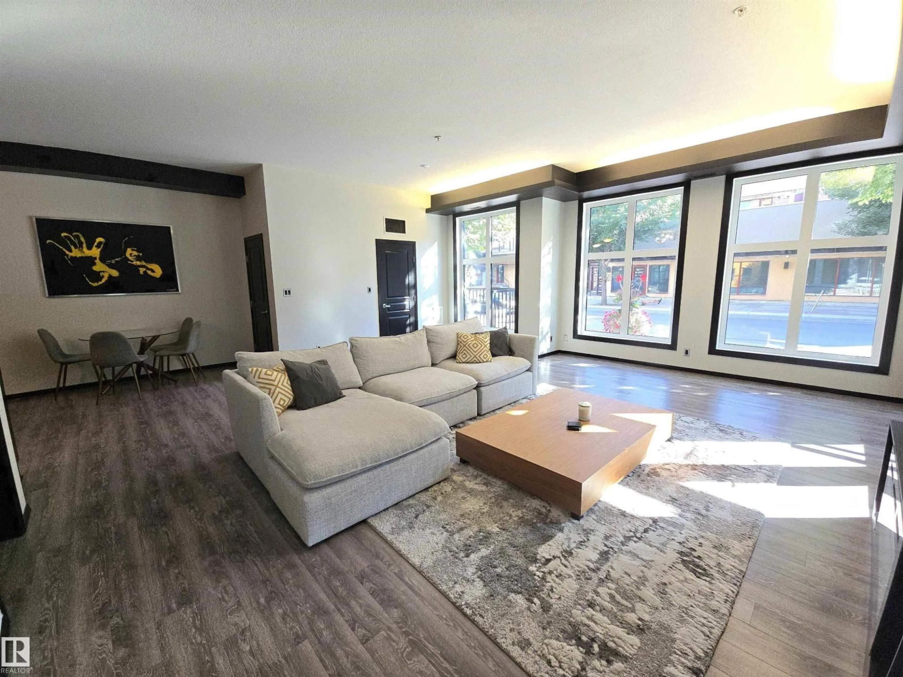 Living room with furniture, wood/laminate floor for #106 - 10531 117 ST, Edmonton Alberta T5H0A8