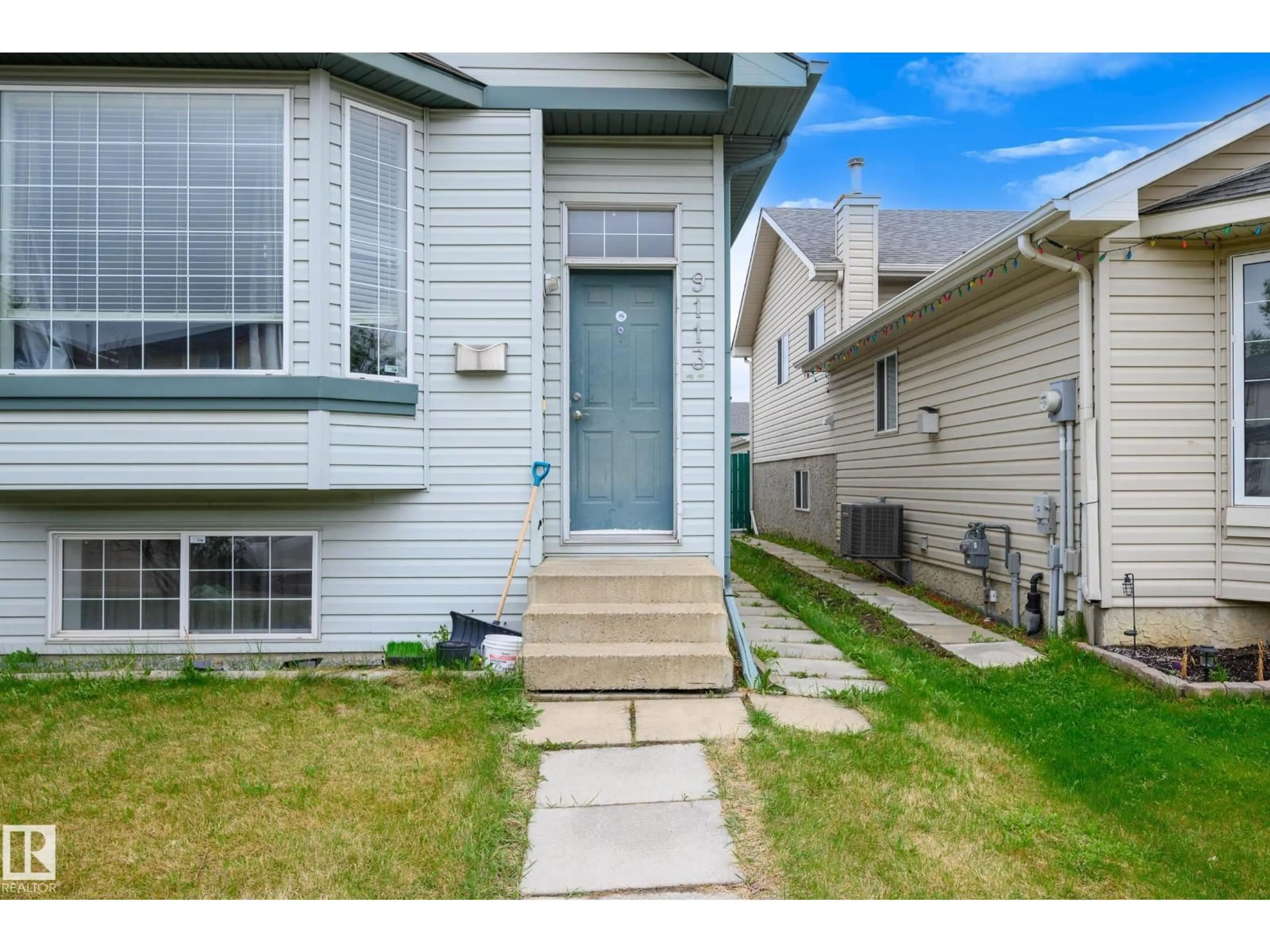 Home with vinyl exterior material, street for 9113 166 AV, Edmonton Alberta T5Z3H5