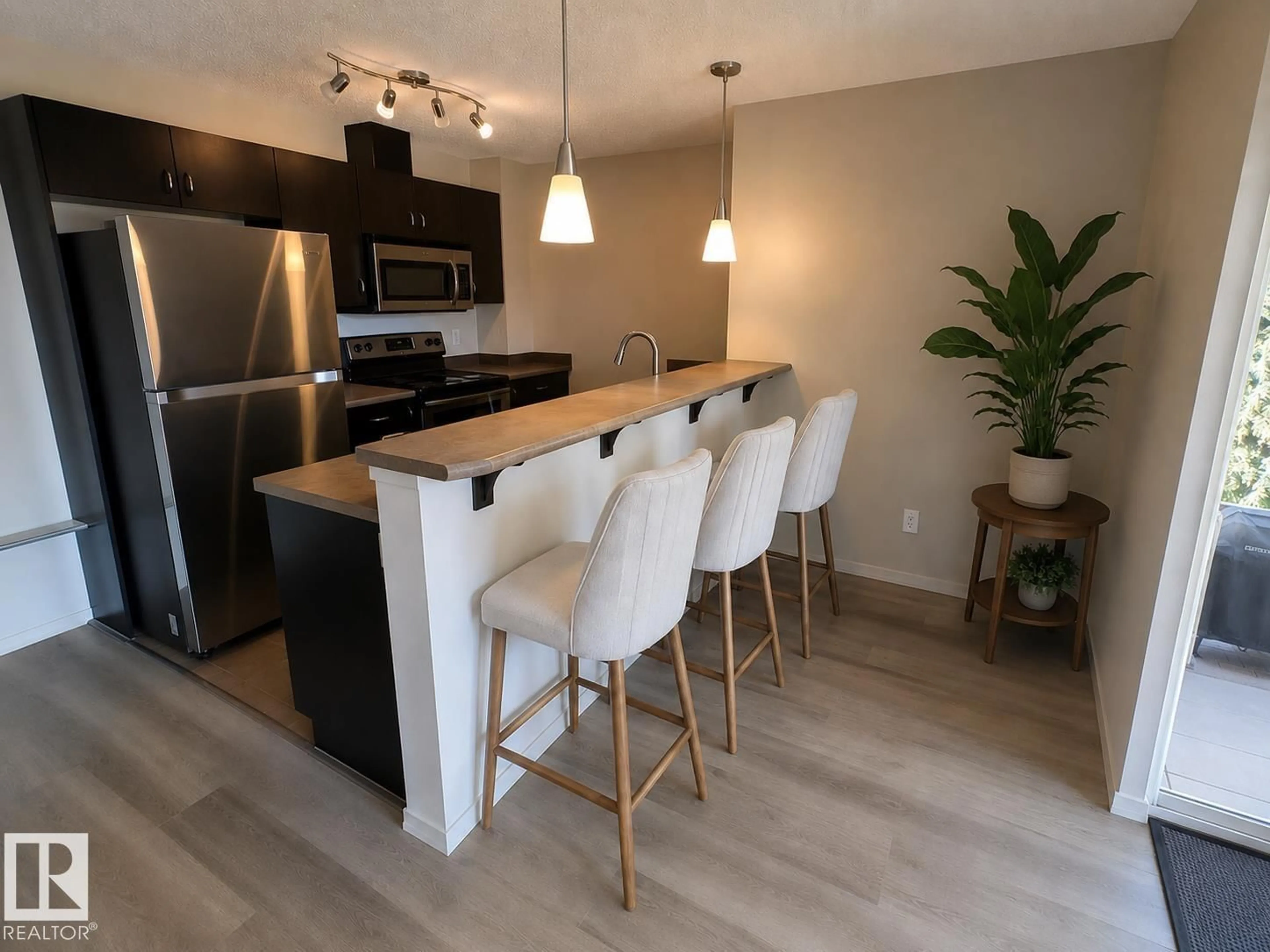 Open concept kitchen, wood/laminate floor for #223 - 1180 HYNDMAN RD, Edmonton Alberta T5A0P8