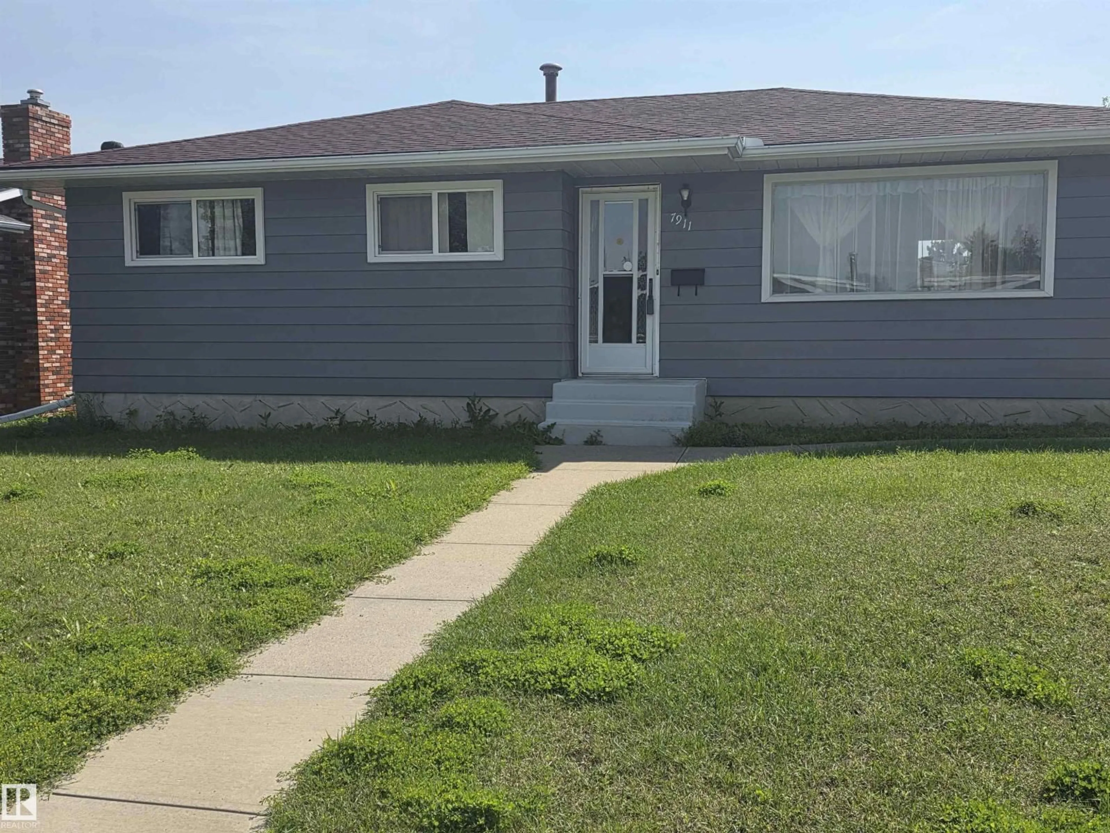 Home with vinyl exterior material, street for 7911 145 AV, Edmonton Alberta T5C2S8