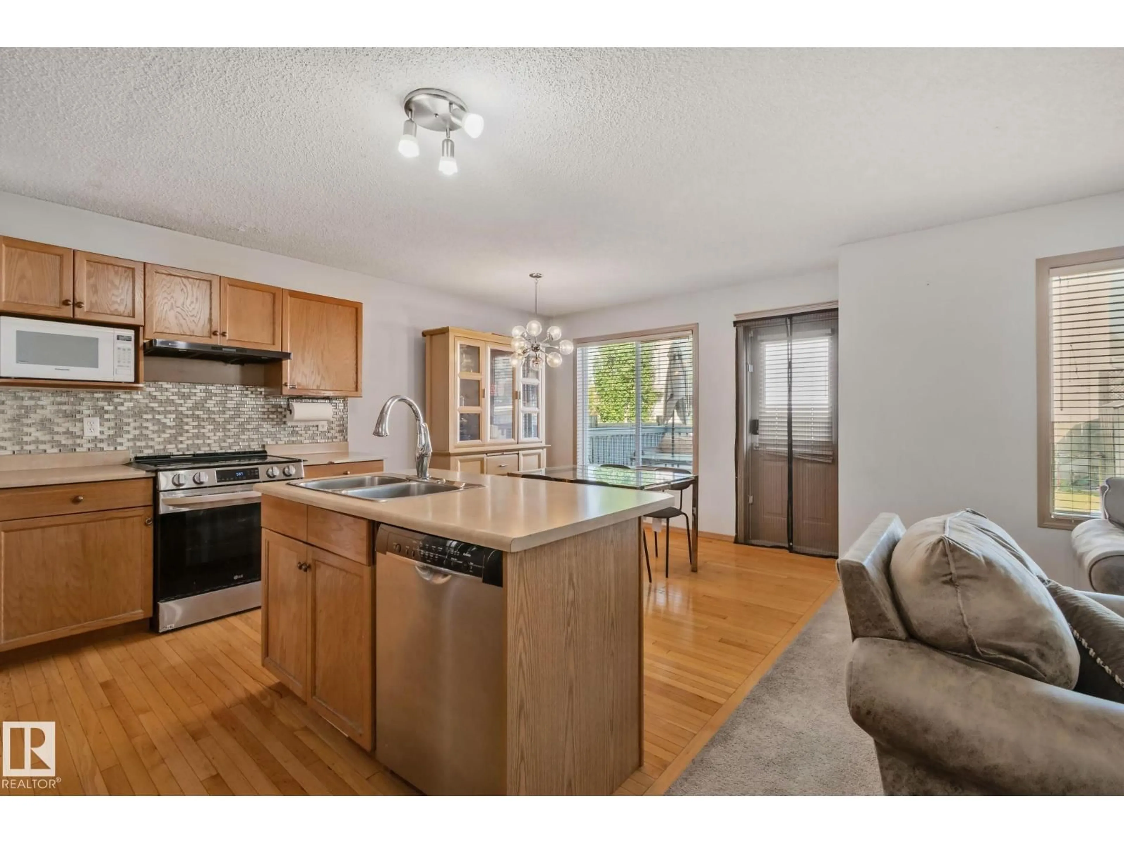 Open concept kitchen, wood/laminate floor for NW - 2819 33 ST, Edmonton Alberta T6T1P5