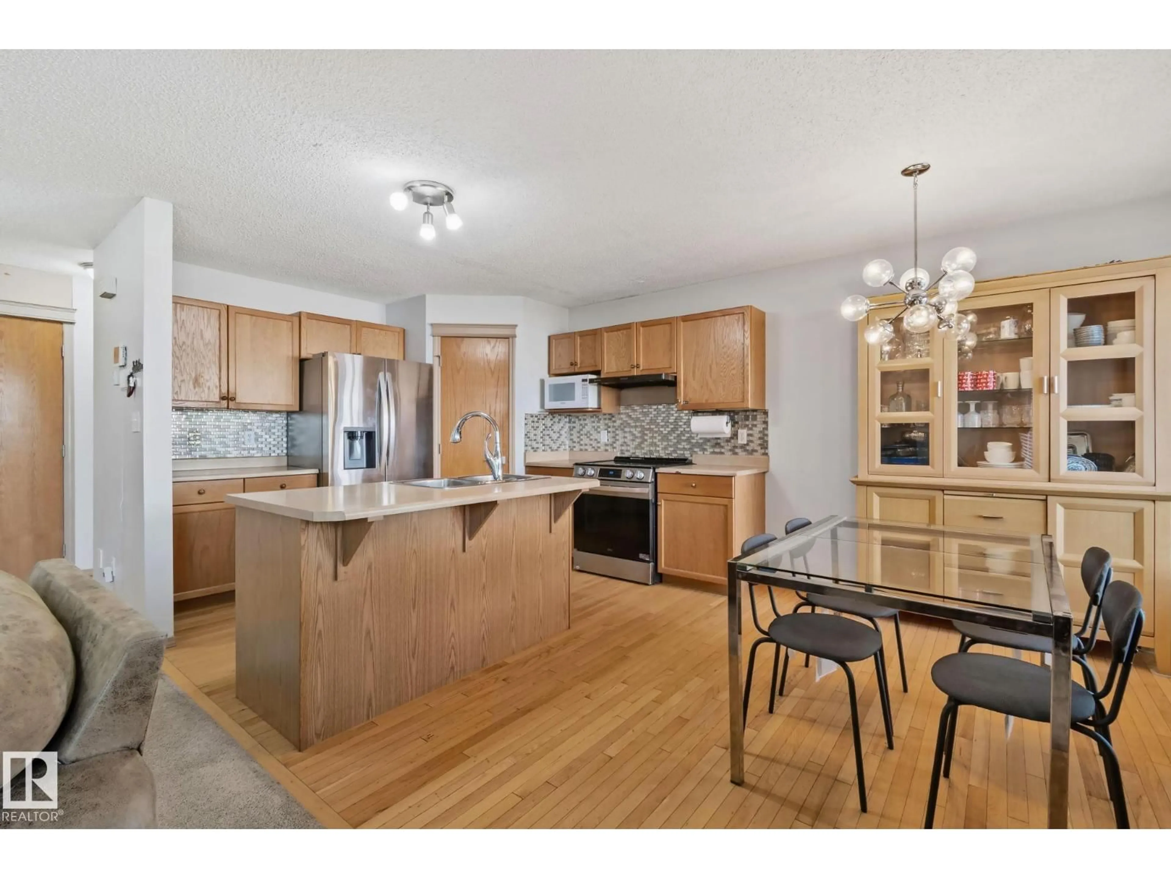 Open concept kitchen, wood/laminate floor for NW - 2819 33 ST, Edmonton Alberta T6T1P5