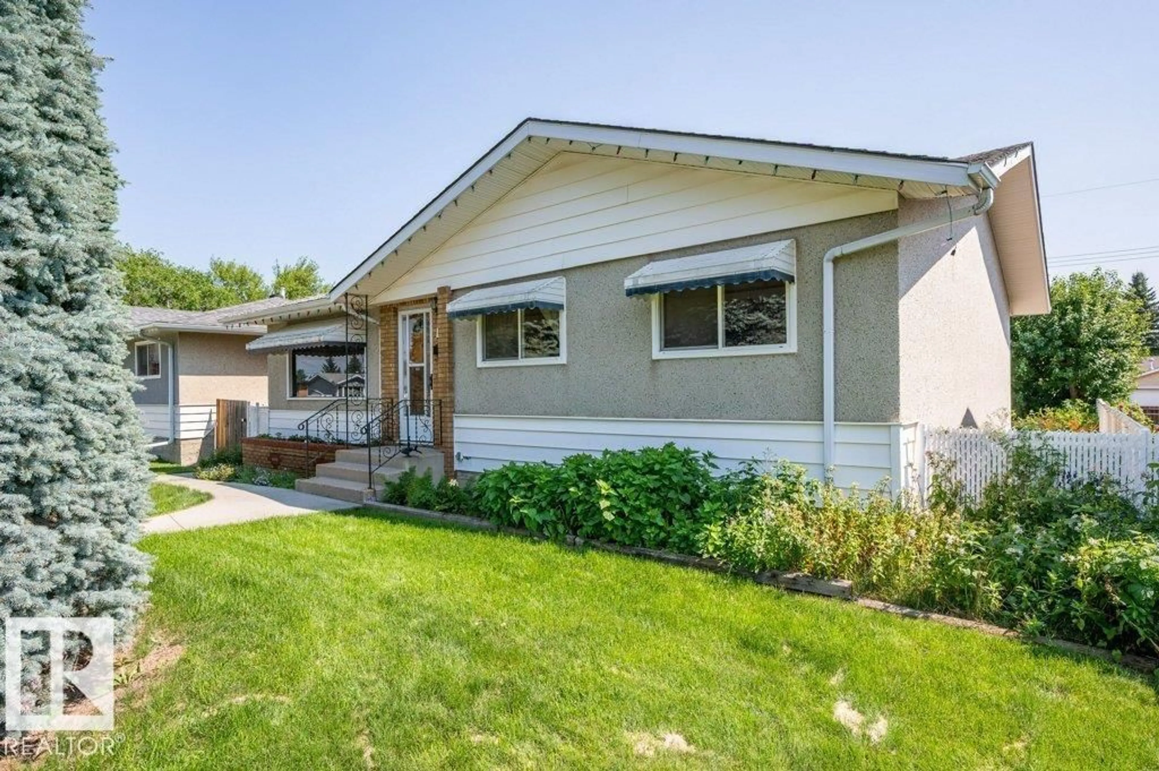 Home with vinyl exterior material, street for 8507 70 ST, Edmonton Alberta T6B1W6