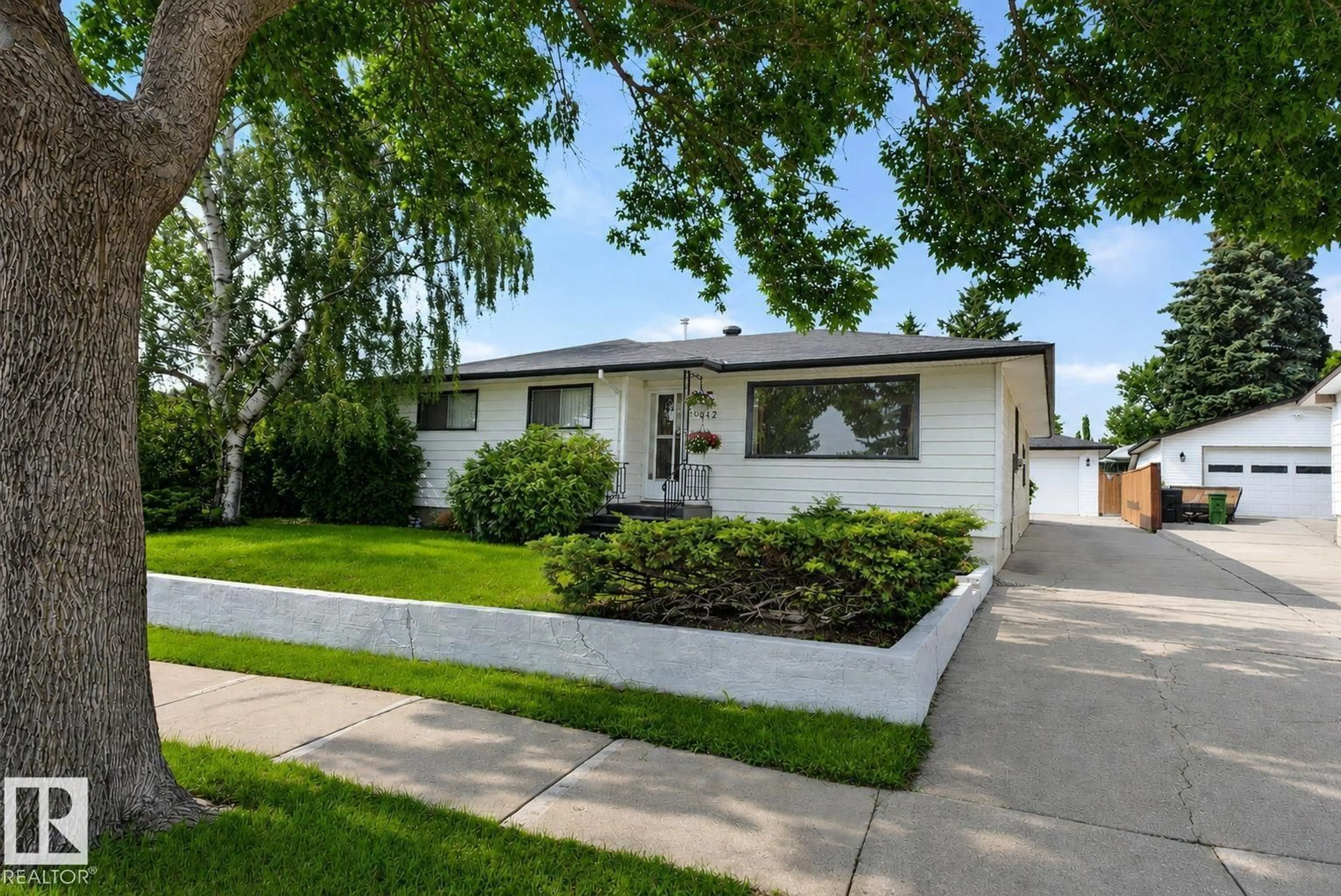 Home with vinyl exterior material, street for NW - 6012 145 AV, Edmonton Alberta T5A1S7