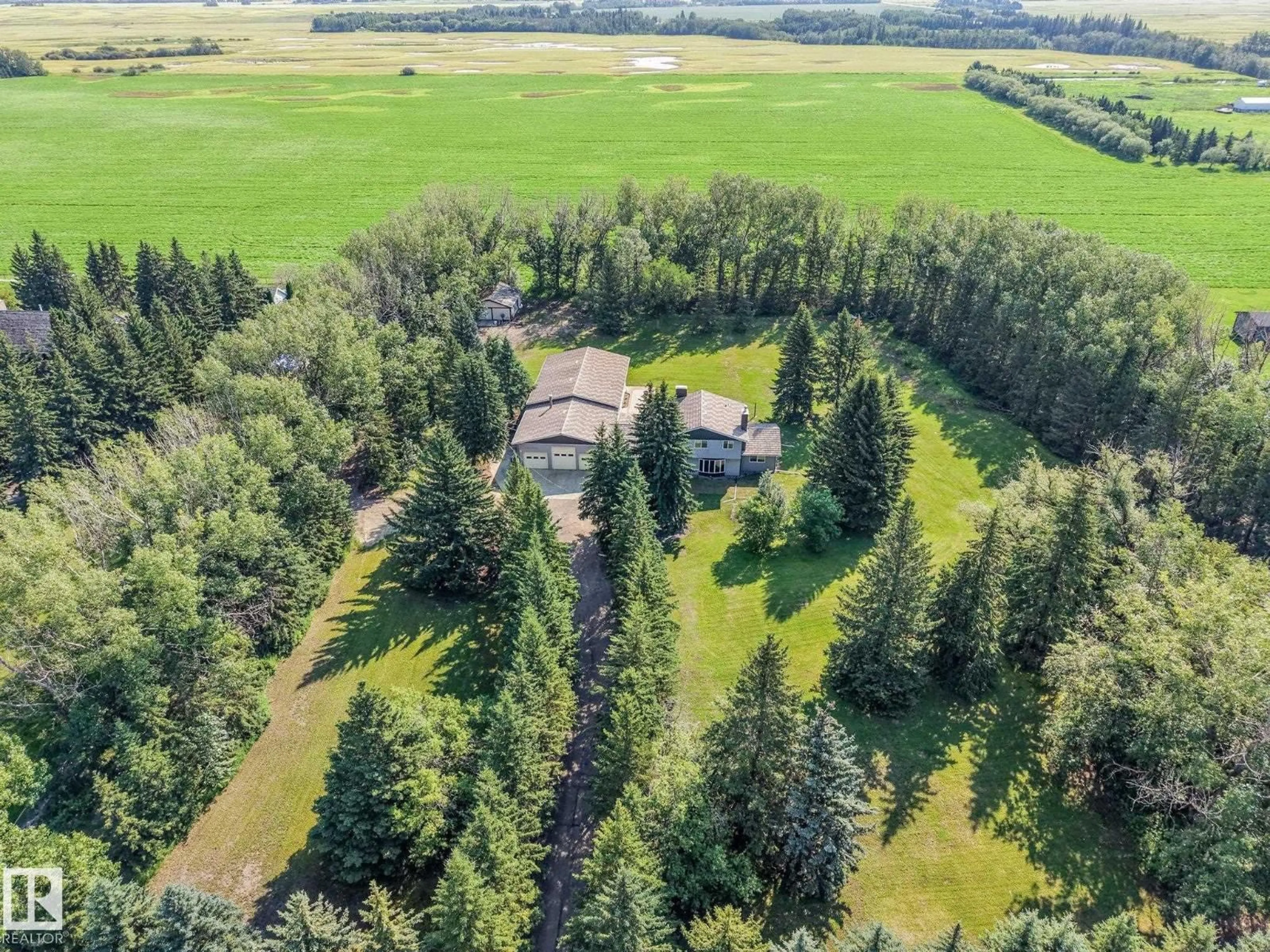 A pic from outside/outdoor area/front of a property/back of a property/a pic from drone, forest/trees view for 50 50202 RGE RD 244, Rural Leduc County Alberta T4X0P4