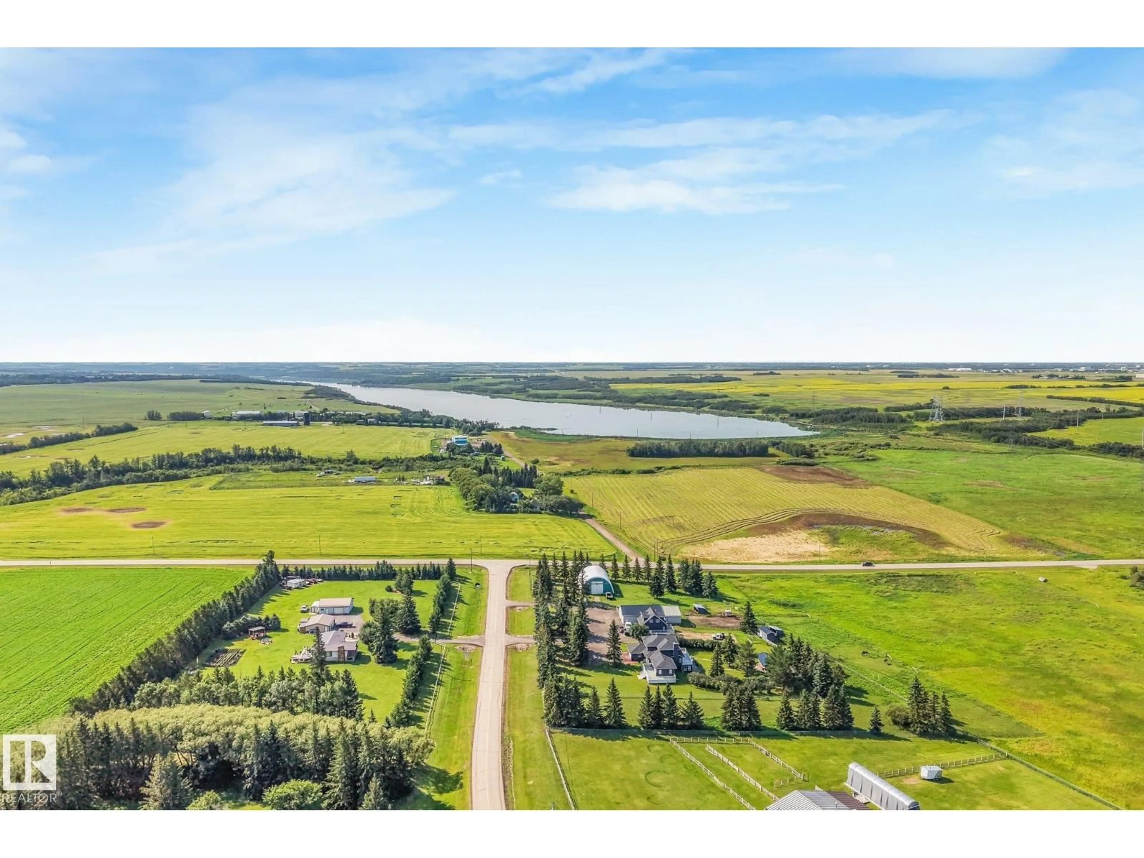 A pic from outside/outdoor area/front of a property/back of a property/a pic from drone, water/lake/river/ocean view for 50 50202 RGE RD 244, Rural Leduc County Alberta T4X0P4