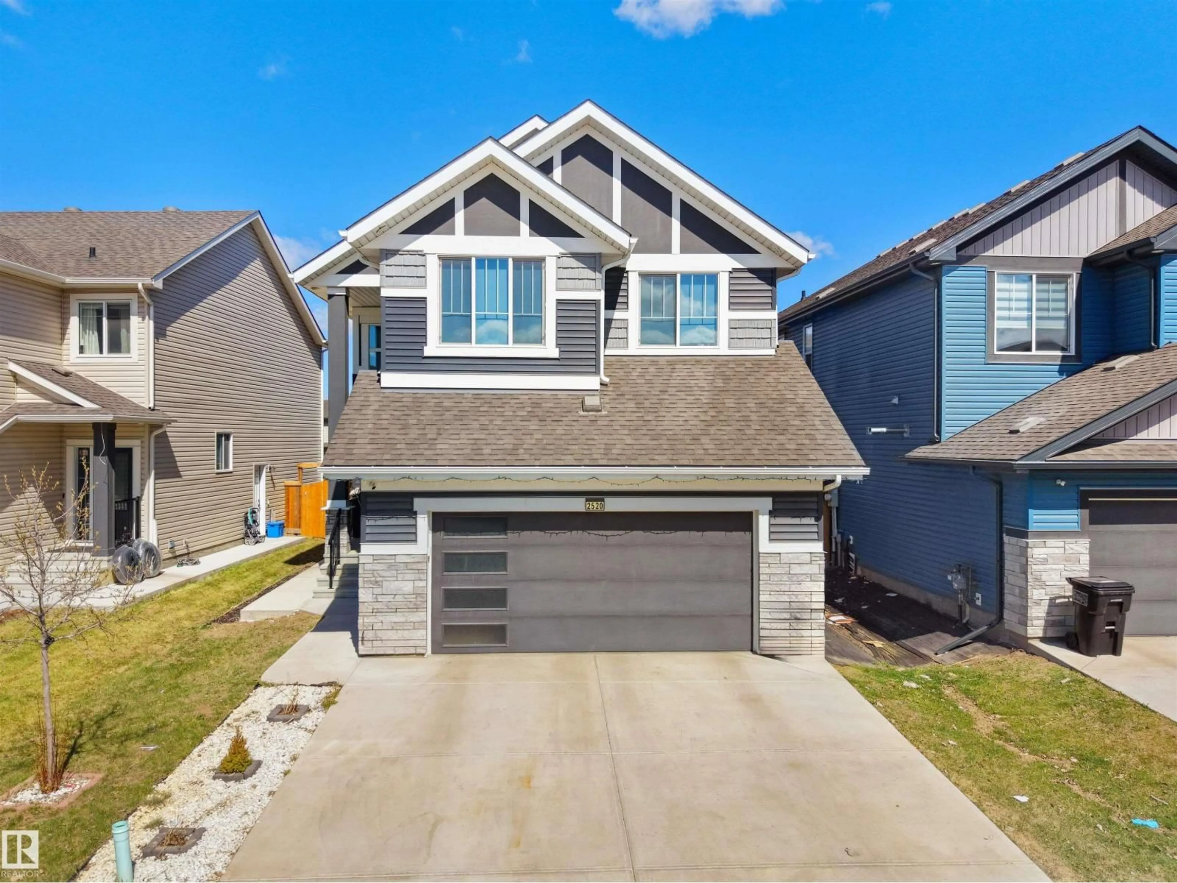 Home with vinyl exterior material, street for 2520 12 AV, Edmonton Alberta T6T2M6