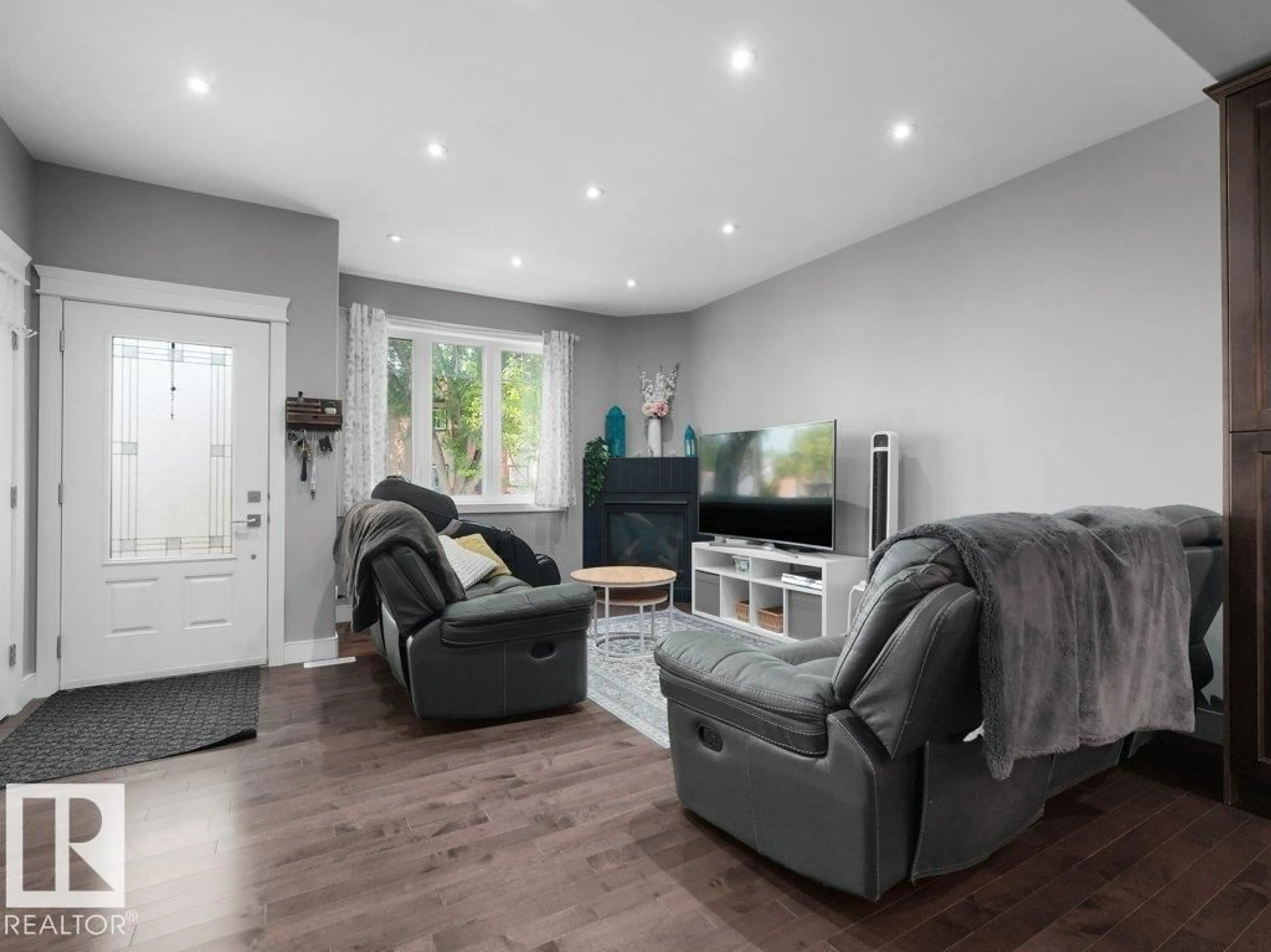 Living room with furniture, wood/laminate floor for 7909 105 AV, Edmonton Alberta T5H0J6