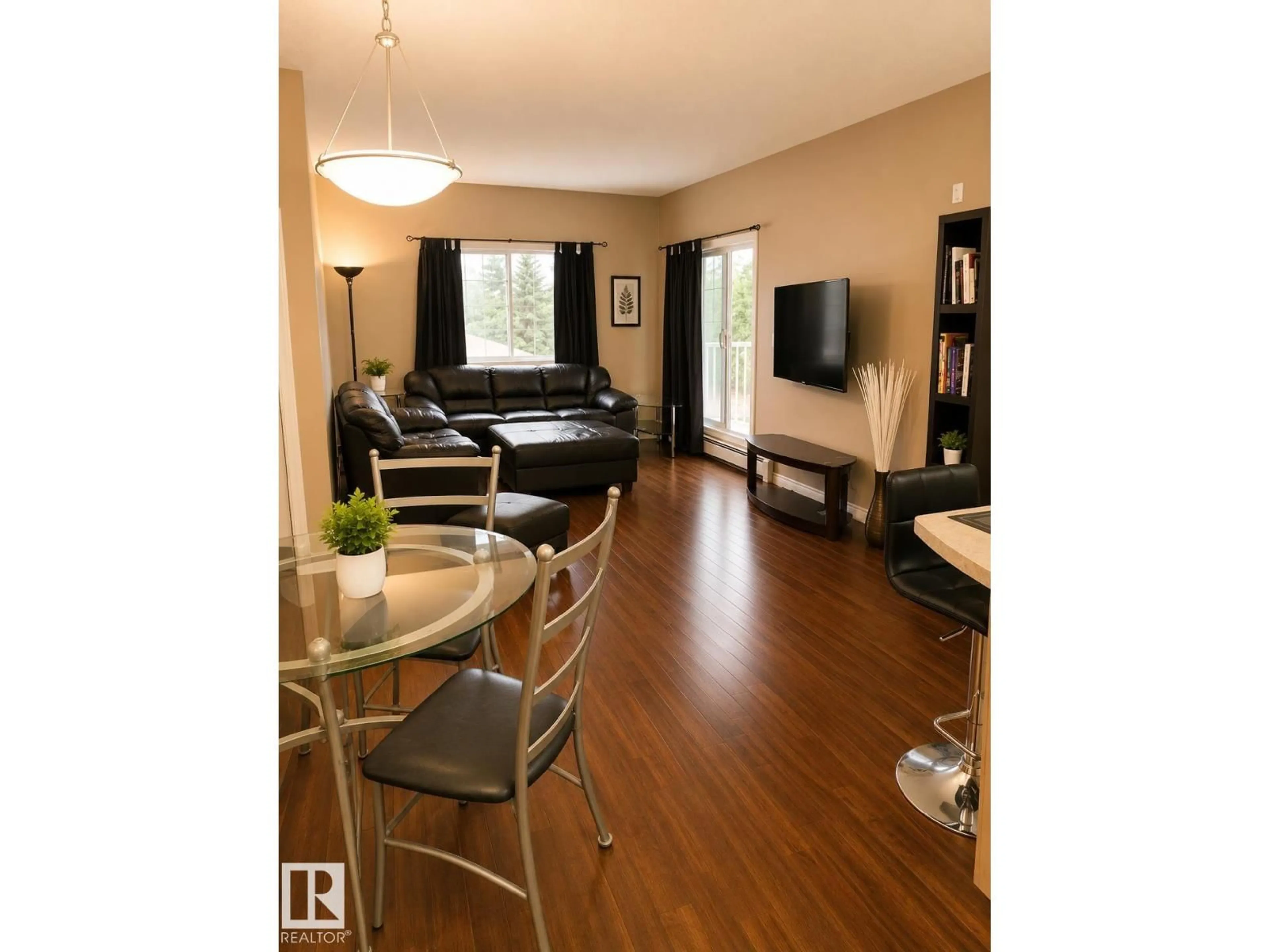 Living room with furniture, wood/laminate floor for 202 - 16715 100 AV, Edmonton Alberta T5P4Z5
