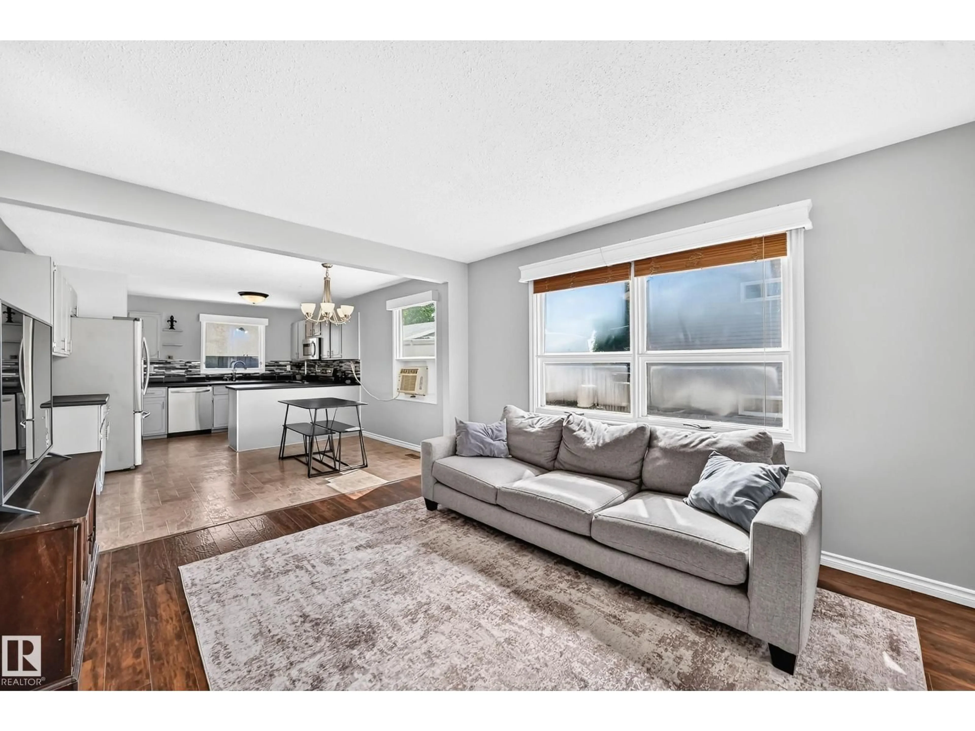 Living room with furniture, wood/laminate floor for 3615 10 AV, Edmonton Alberta T6L2L2