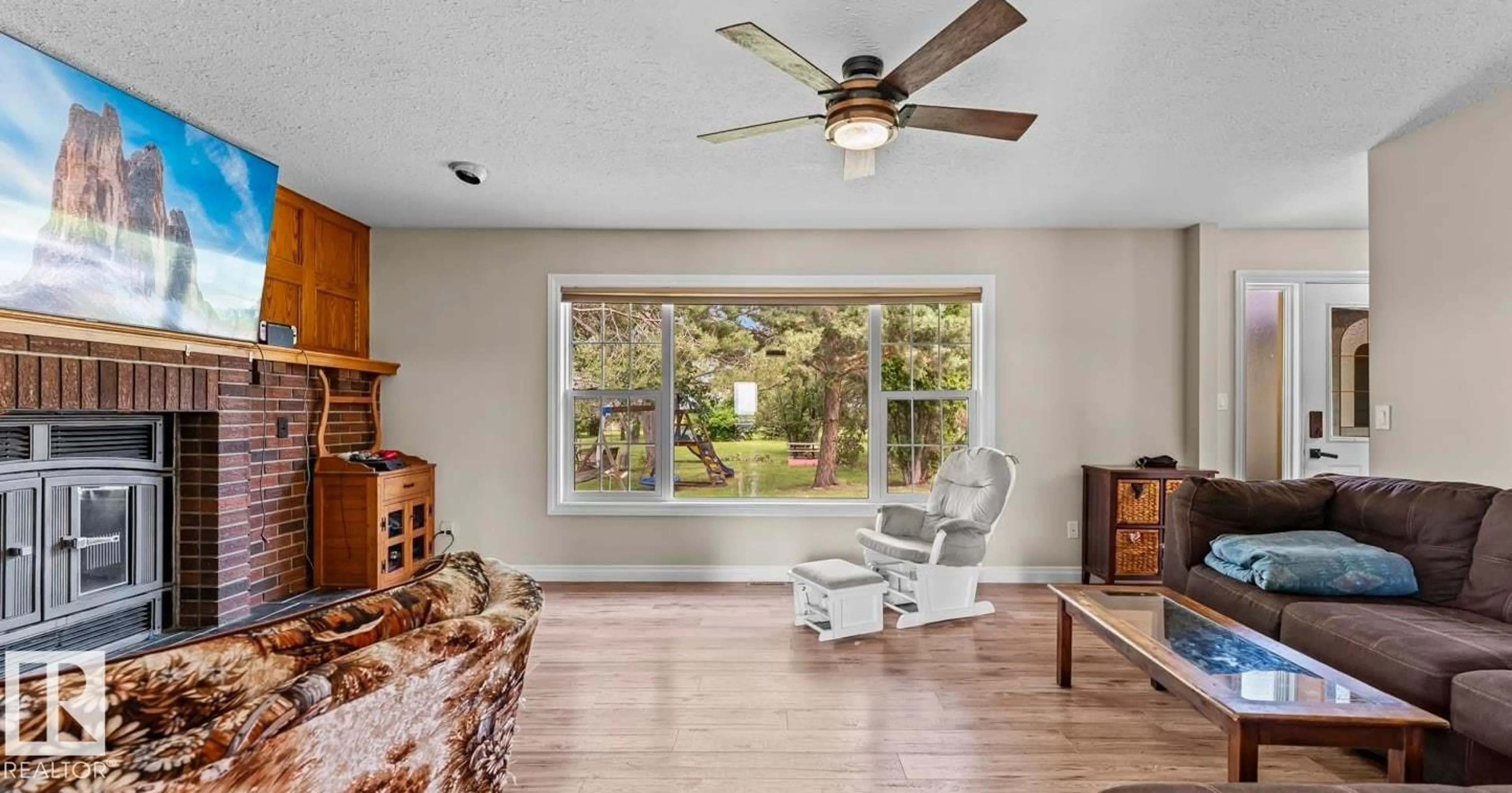 Living room with furniture, wood/laminate floor for 45329 TWP RD 610, Rural Bonnyville M.D. Alberta T9N2J1