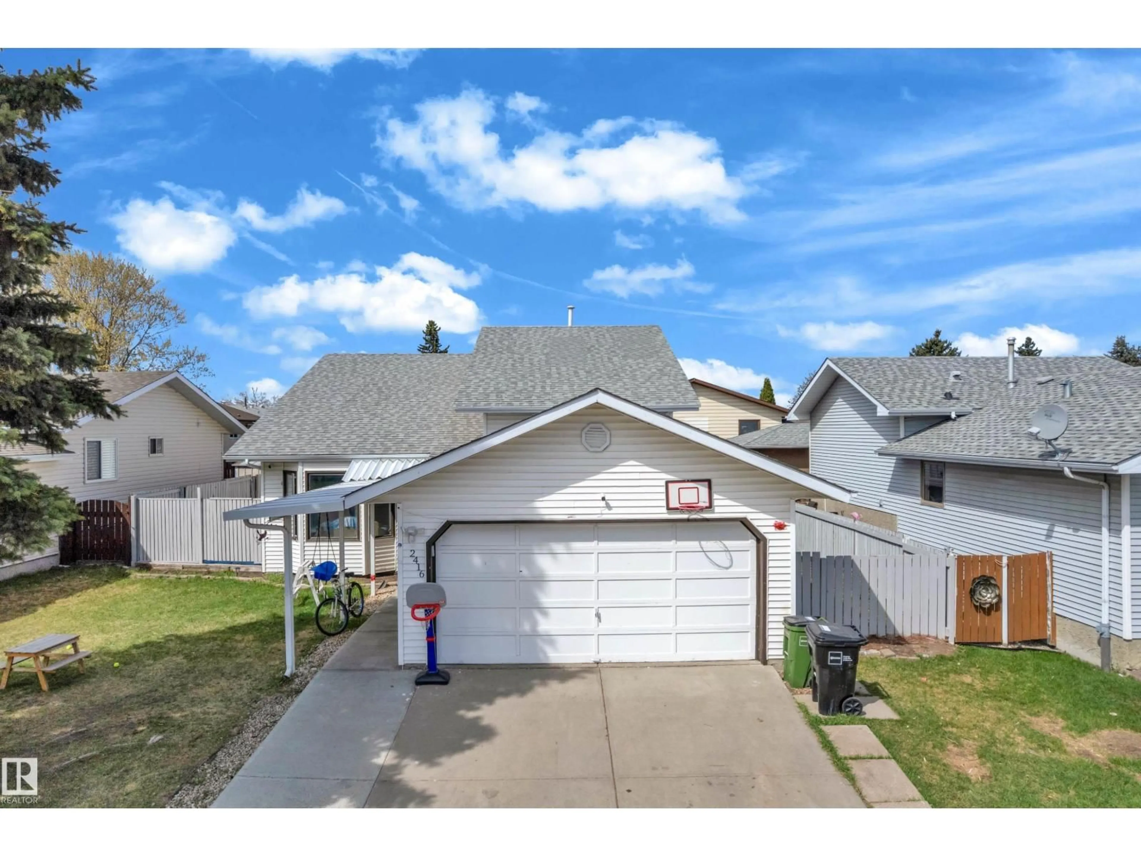 Home with vinyl exterior material, street for 2416 35 ST, Edmonton Alberta T6L4M3