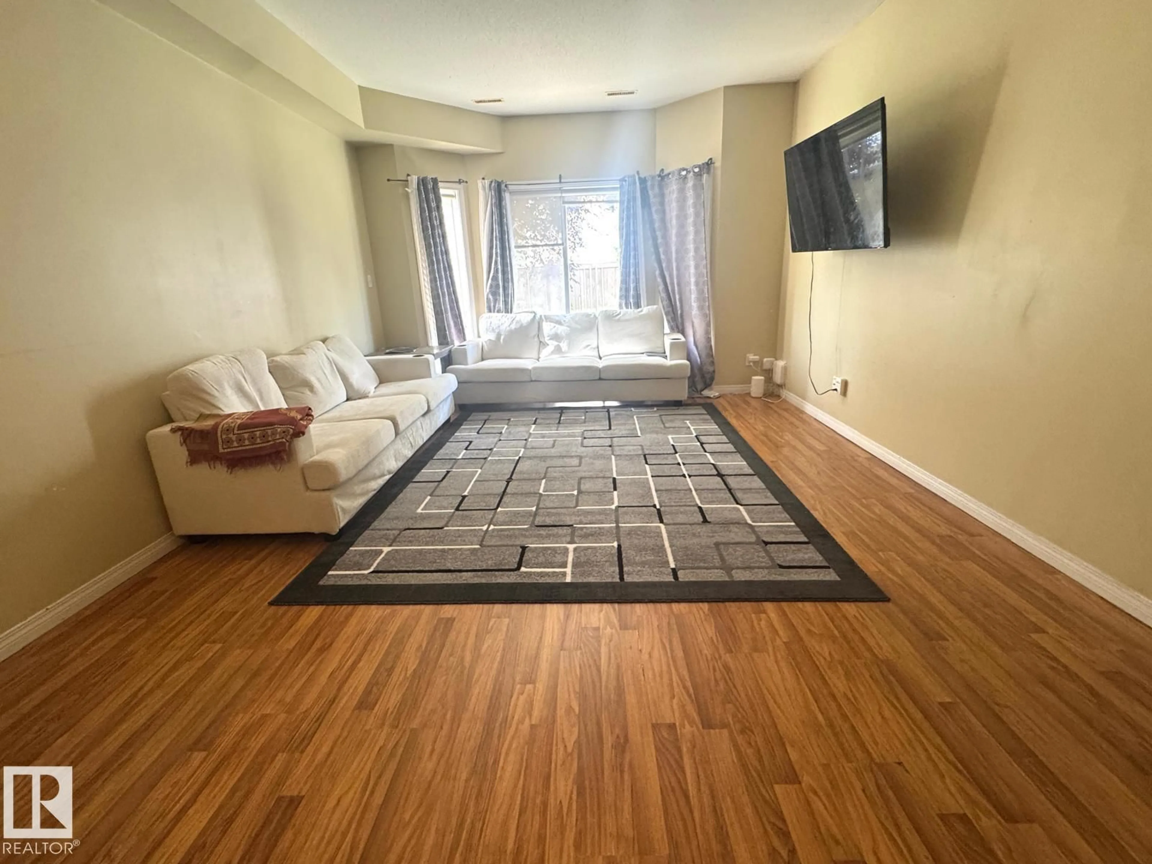 Living room with furniture, unknown for #117 - 4304 139 AV, Edmonton Alberta T5Y0H6