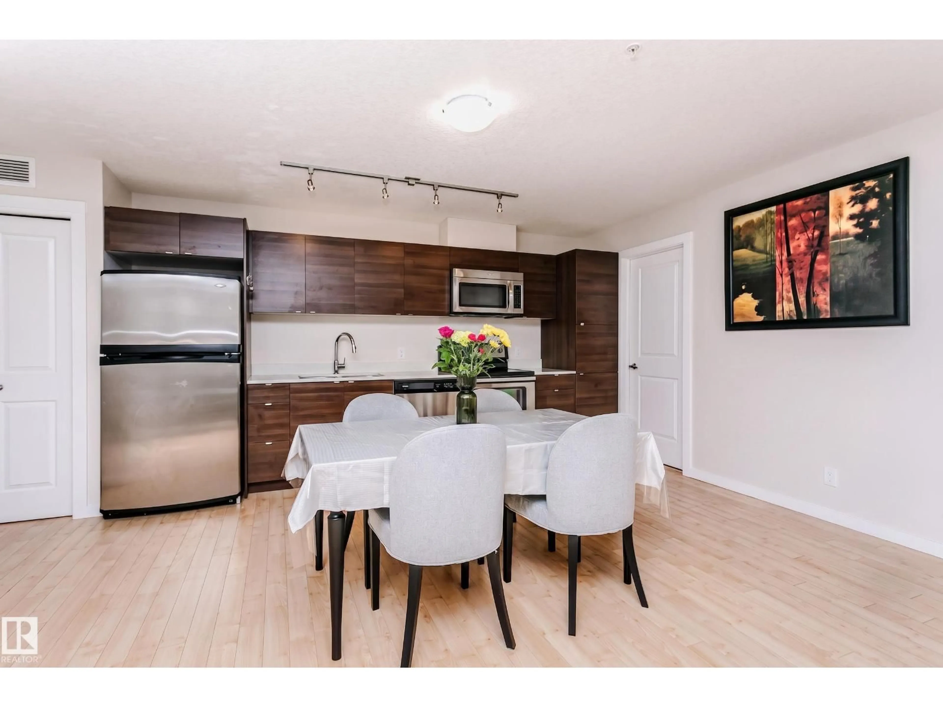Open concept kitchen, wood/laminate floor for #104 - 9519 160 AV, Edmonton Alberta T5Z0N1