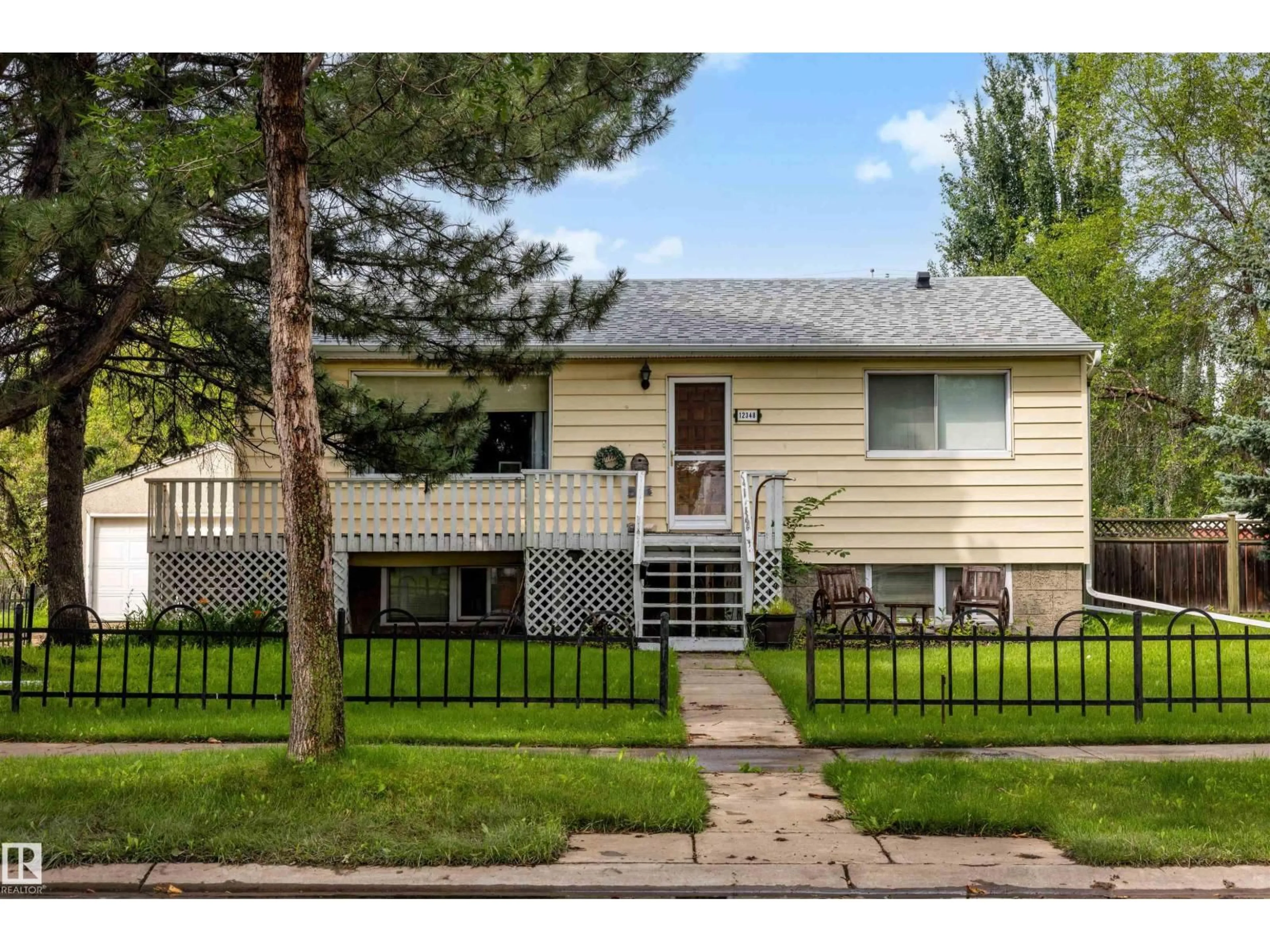 Home with vinyl exterior material, street for 12348 128 ST, Edmonton Alberta T5L1C7