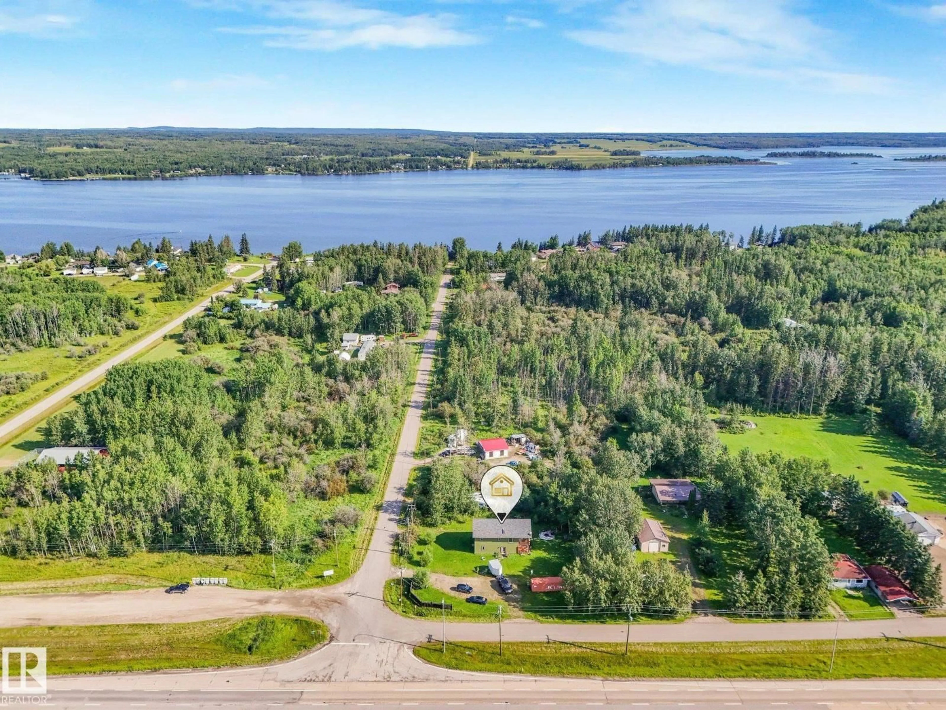 A pic from outside/outdoor area/front of a property/back of a property/a pic from drone, water/lake/river/ocean view for 6132 HGHWAY 16, Rural Parkland County Alberta T0E0W0