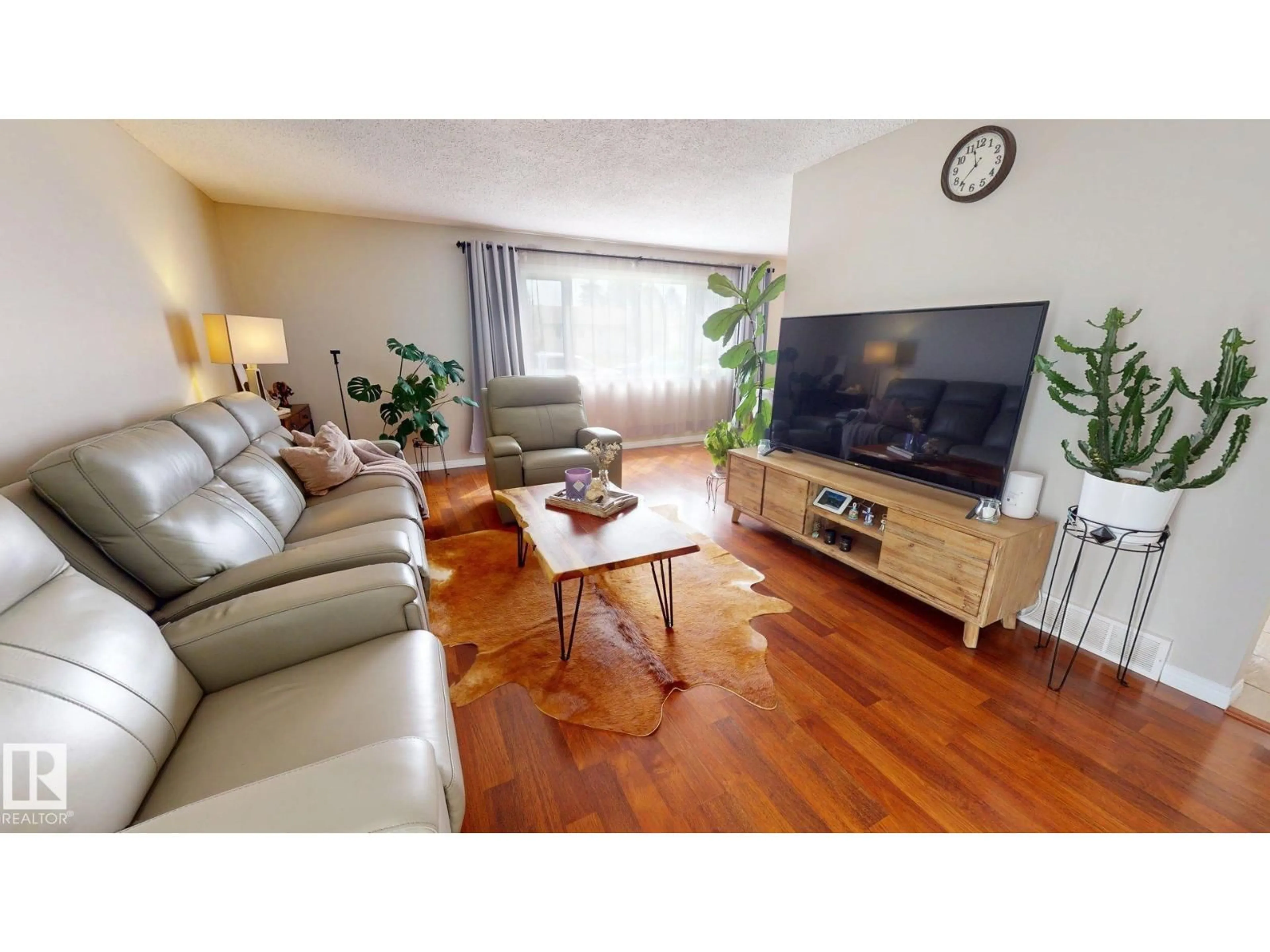 Living room with furniture, wood/laminate floor for 7935 22 AV, Edmonton Alberta T6K1Z2