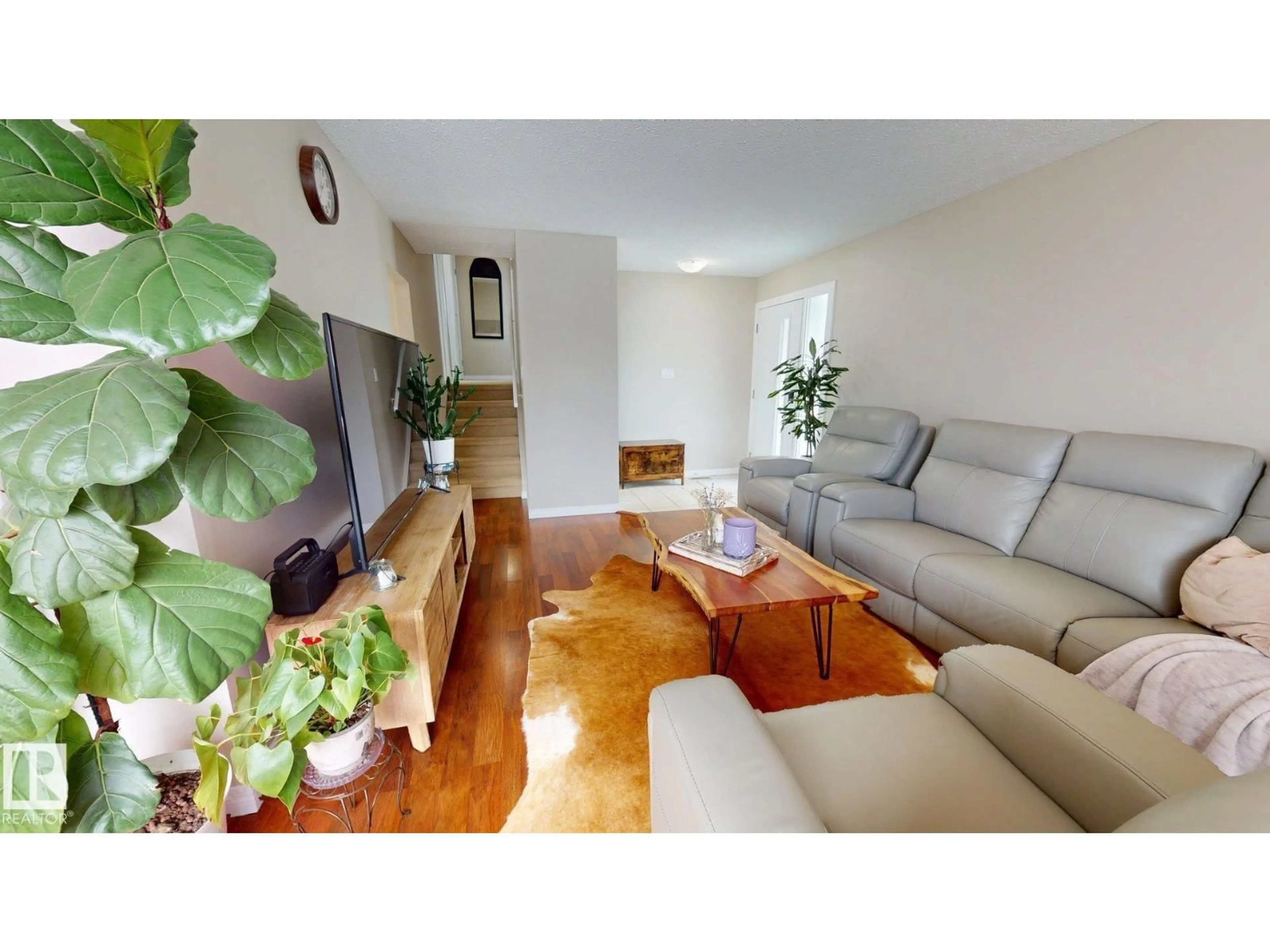 Living room with furniture, wood/laminate floor for 7935 22 AV, Edmonton Alberta T6K1Z2