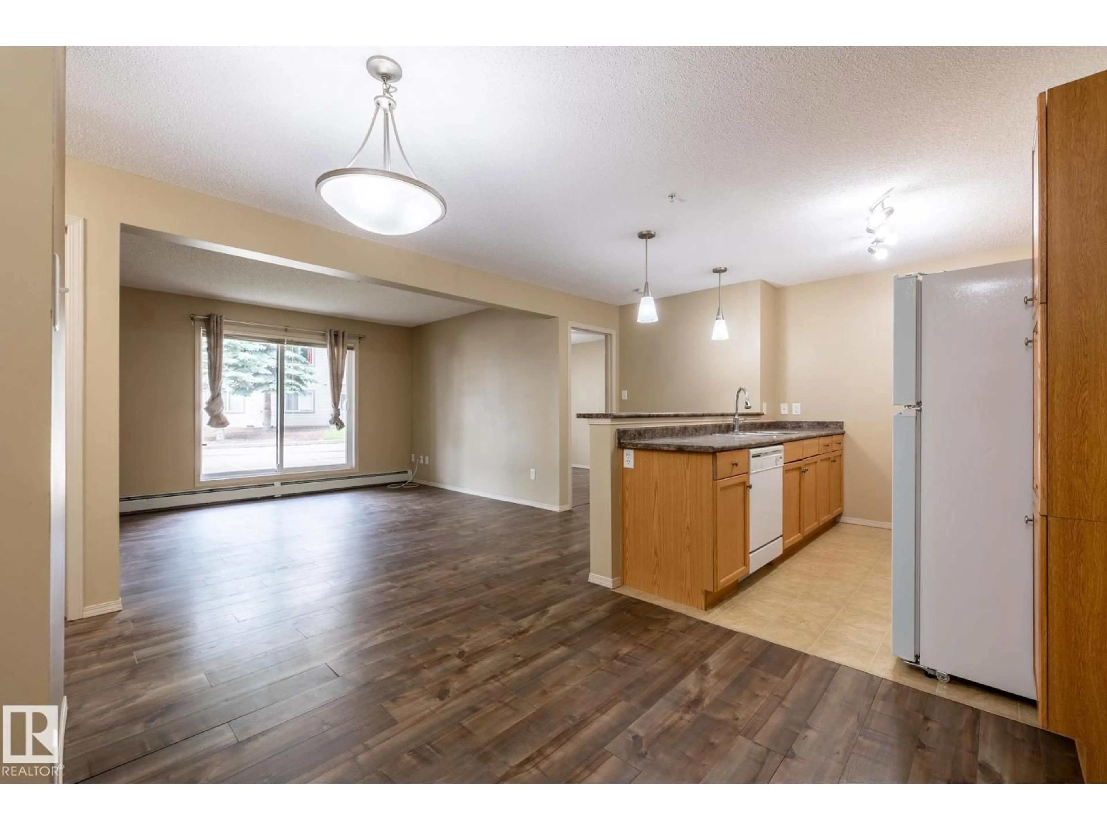 Open concept kitchen, wood/laminate floor for 1188 - 106 HYNDMAN RD, Edmonton Alberta T5A0E9