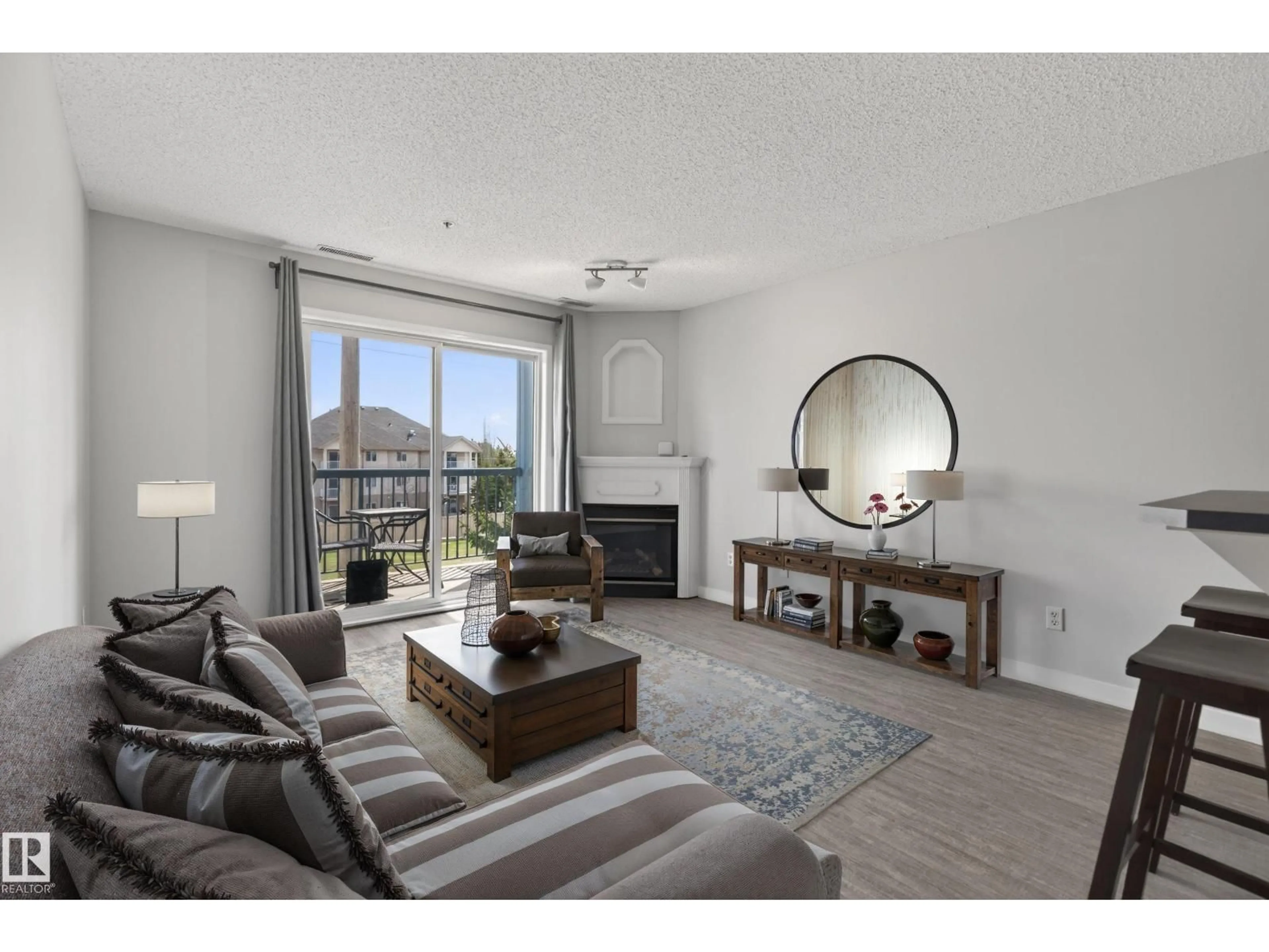 Living room with furniture, wood/laminate floor for NW - 319 16303 95 ST, Edmonton Alberta T5Z3V1