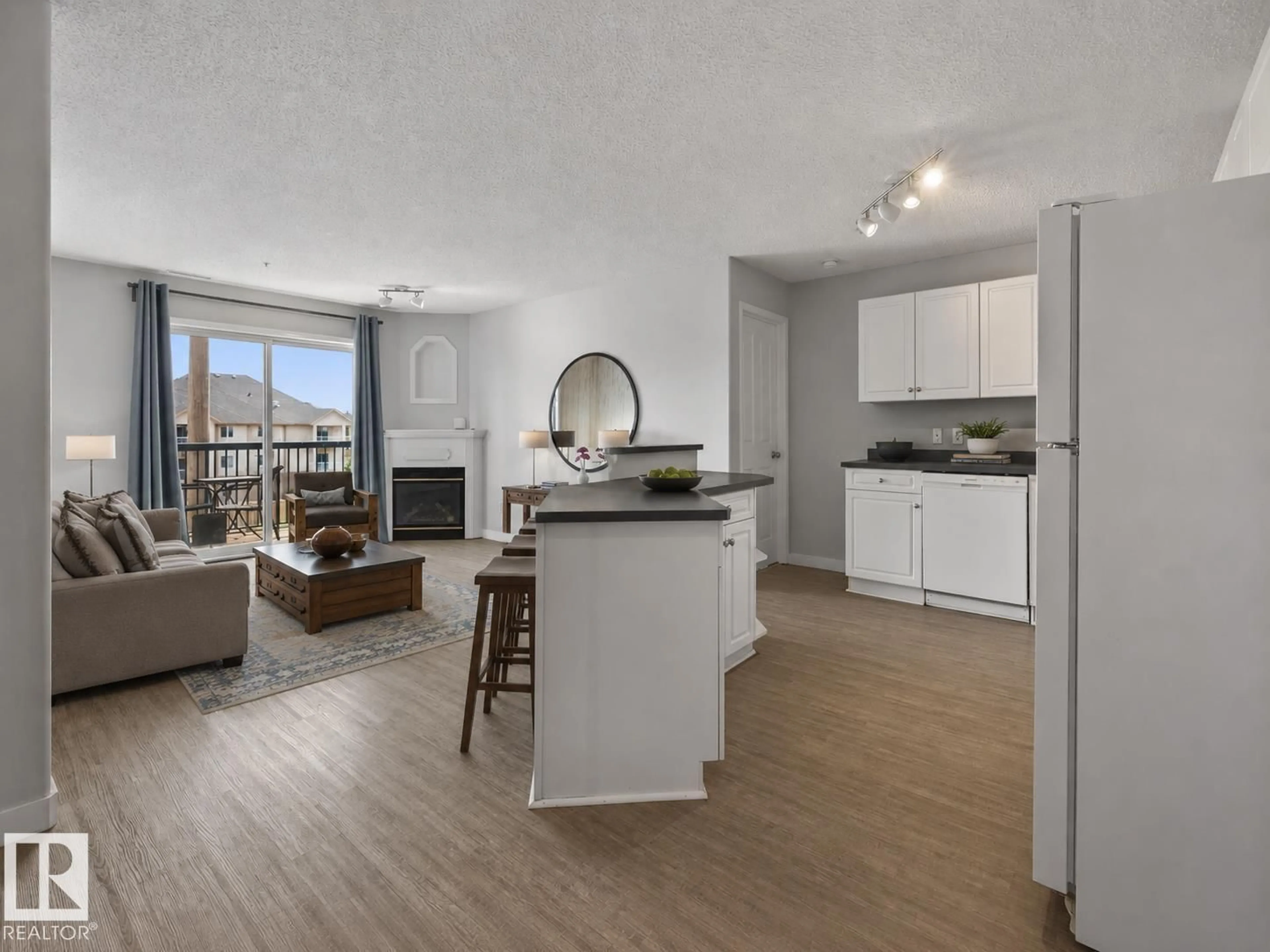 Open concept kitchen, wood/laminate floor for NW - 319 16303 95 ST, Edmonton Alberta T5Z3V1