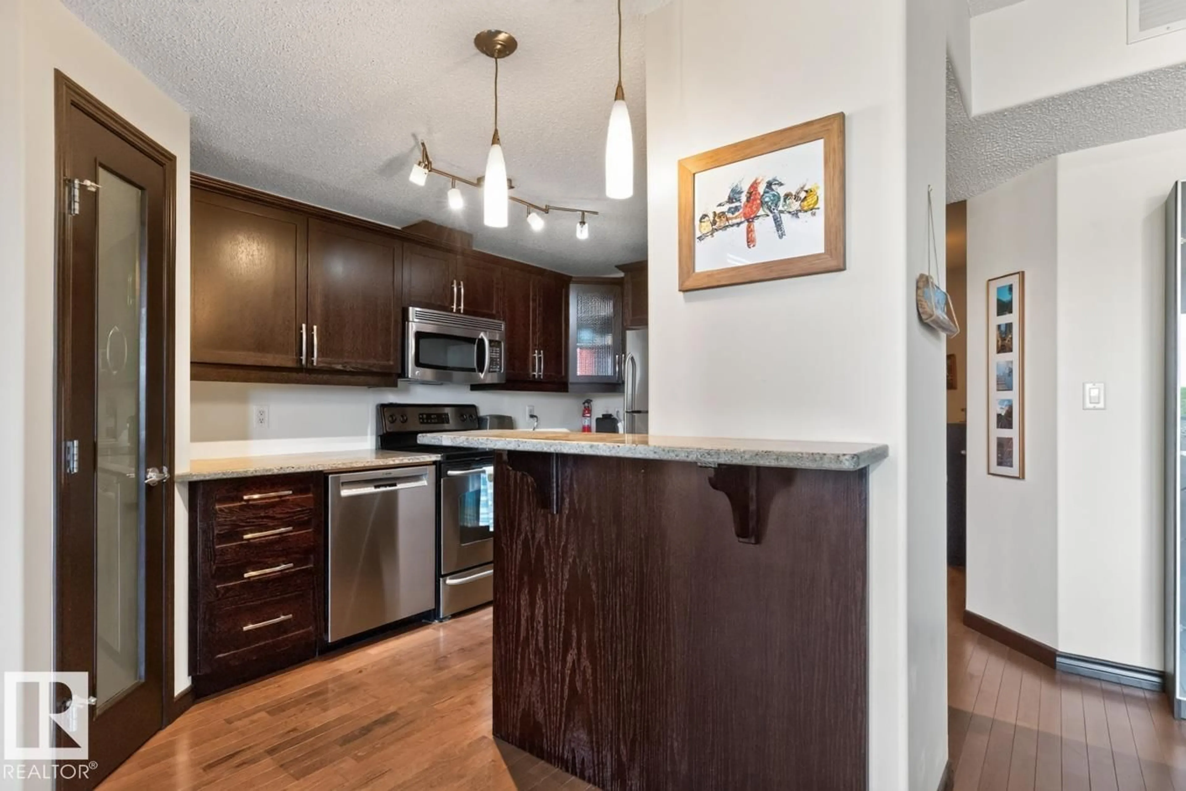Open concept kitchen, wood/laminate floor for 801 - 9707 106 ST NW, Edmonton Alberta T5K0B7