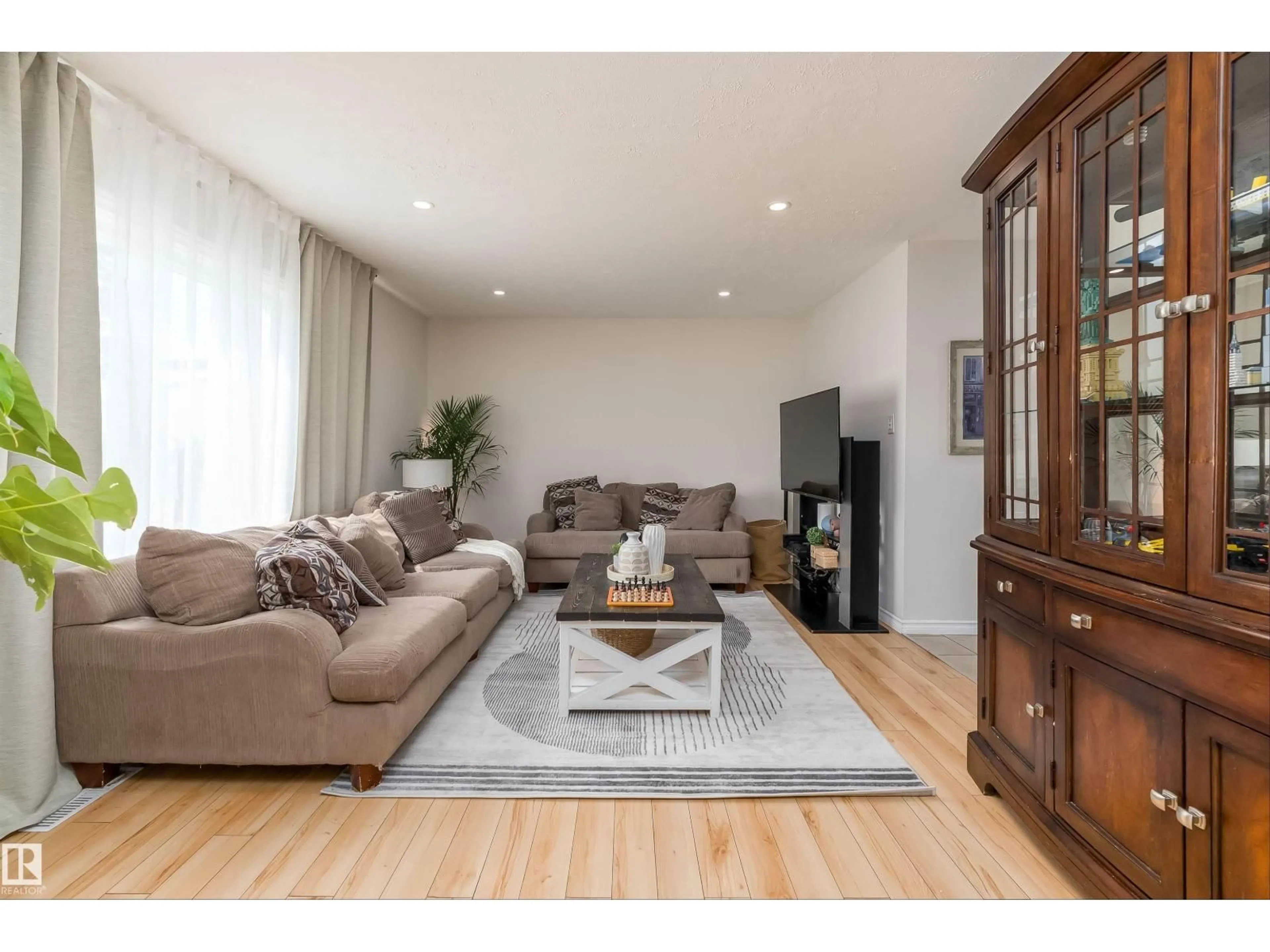 Living room with furniture, wood/laminate floor for 11236 40 AV, Edmonton Alberta T6J0R2
