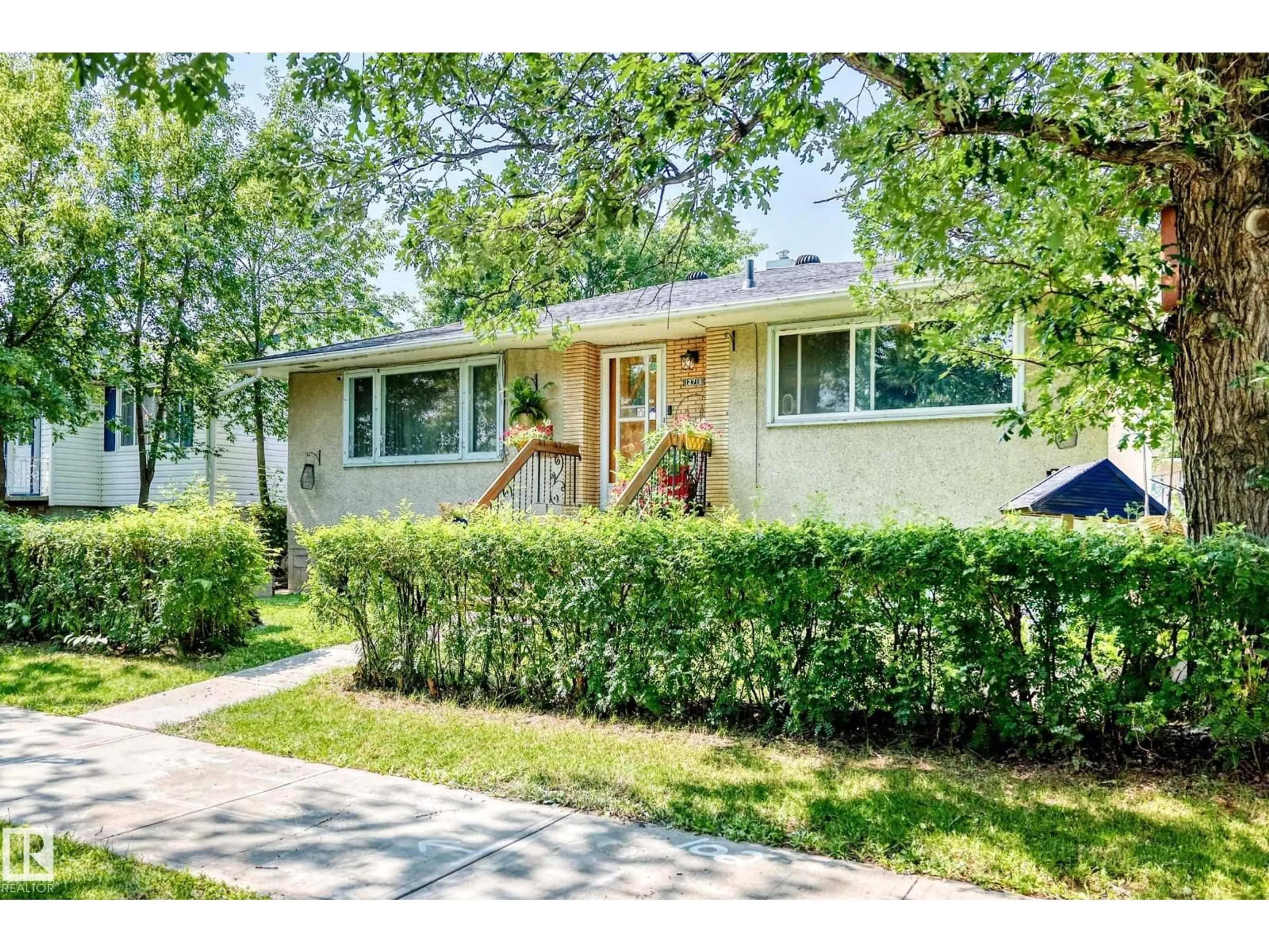 Home with vinyl exterior material, street for 12718 126 ST, Edmonton Alberta T5L0X8