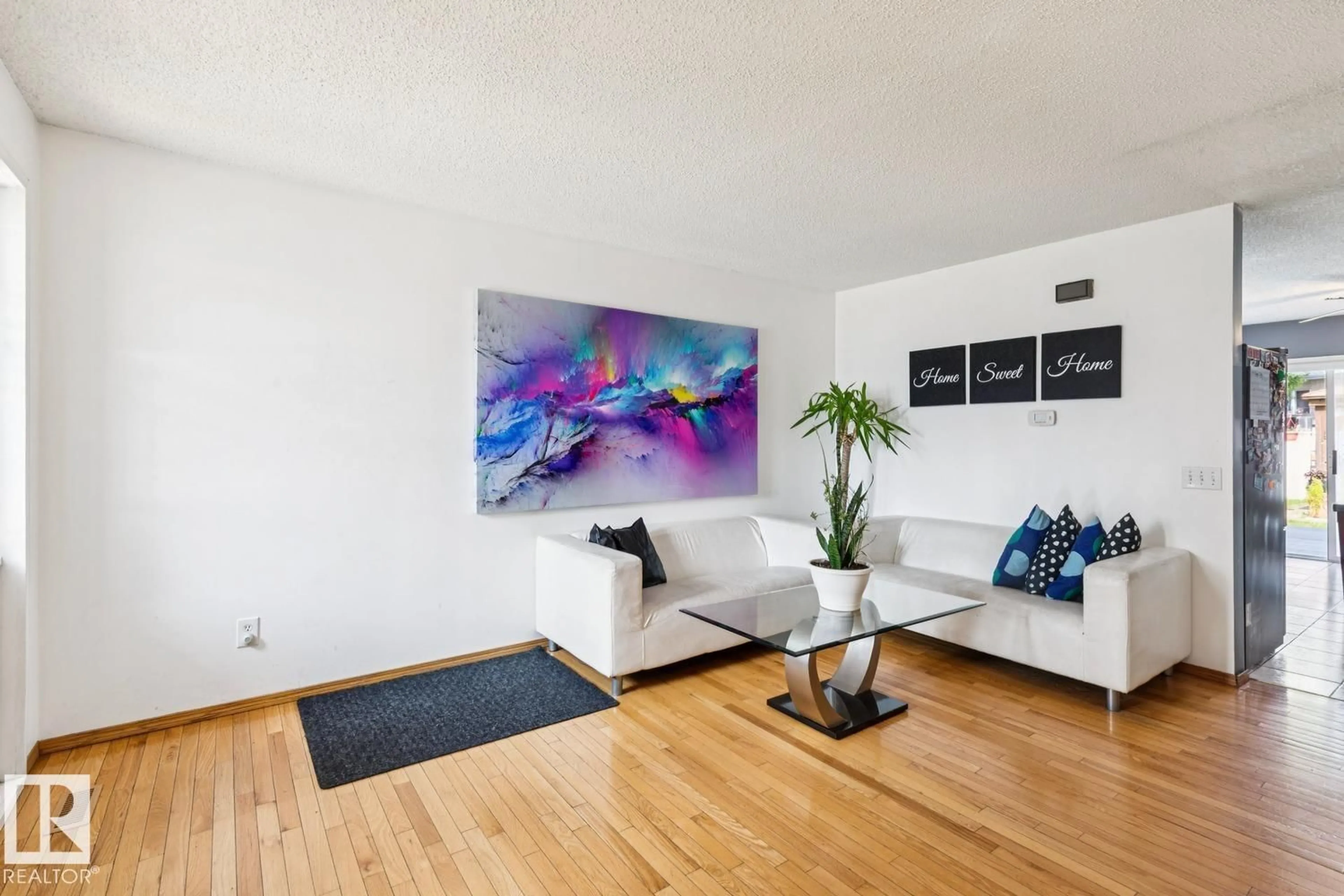 Living room with furniture, wood/laminate floor for 7912 154 AV, Edmonton Alberta T5Z2Z2