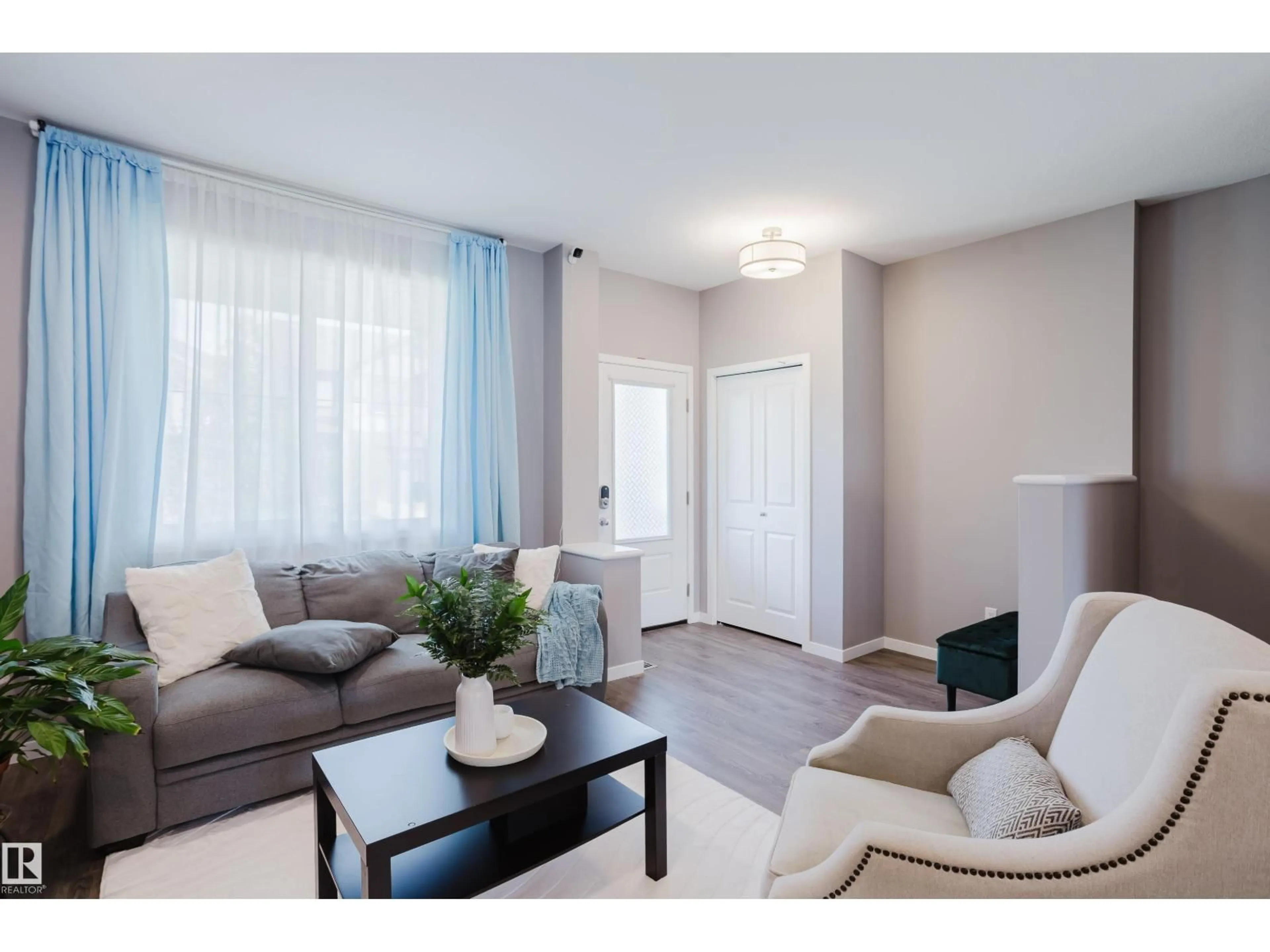 Living room with furniture, wood/laminate floor for 4331 COOKE LN, Edmonton Alberta T6W4M7