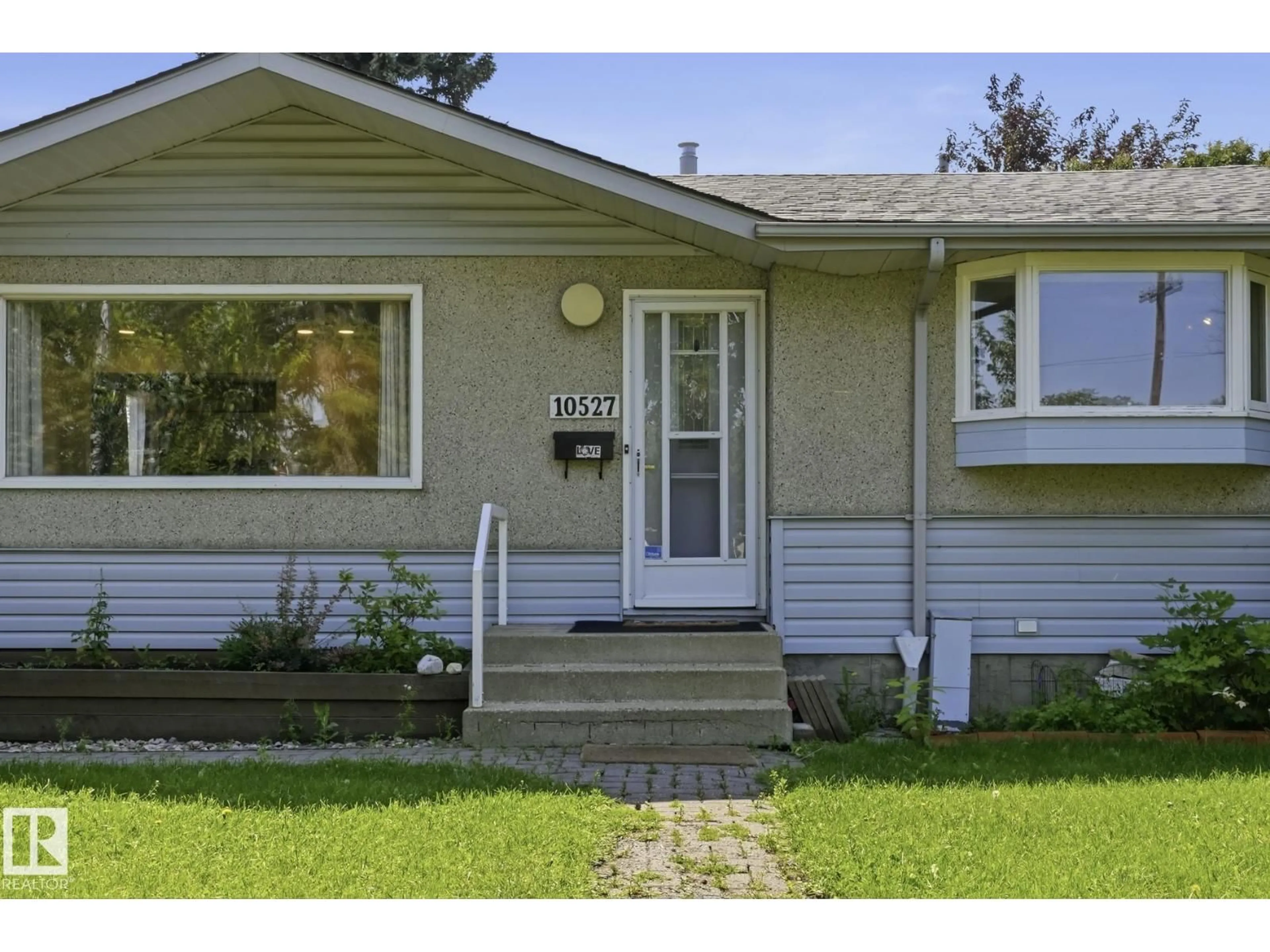 Home with vinyl exterior material, street for 10527 137 AV, Edmonton Alberta T5E1Z1