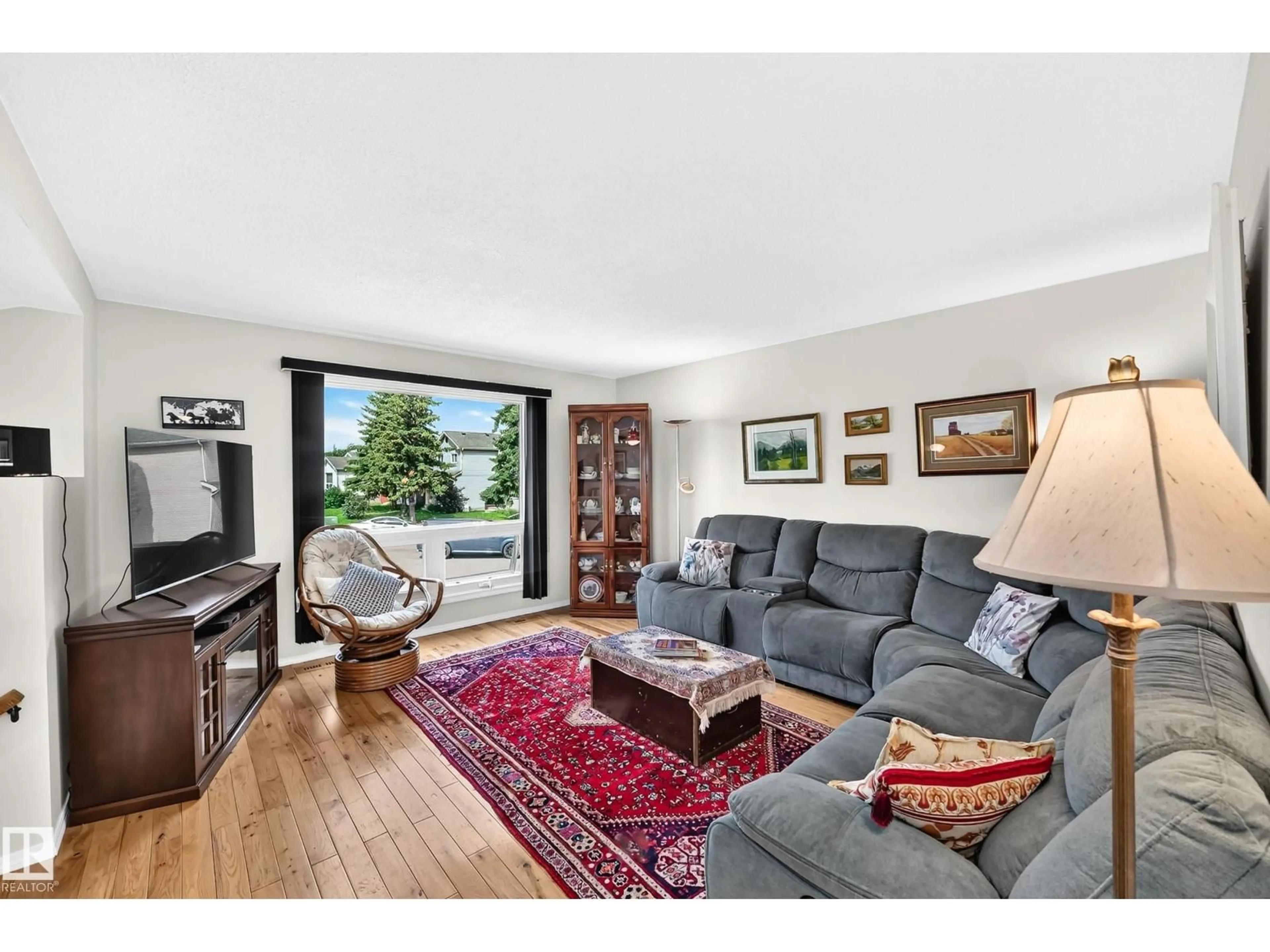 Living room with furniture, wood/laminate floor for 371 KIRKPATRICK CR, Edmonton Alberta T6L5C9