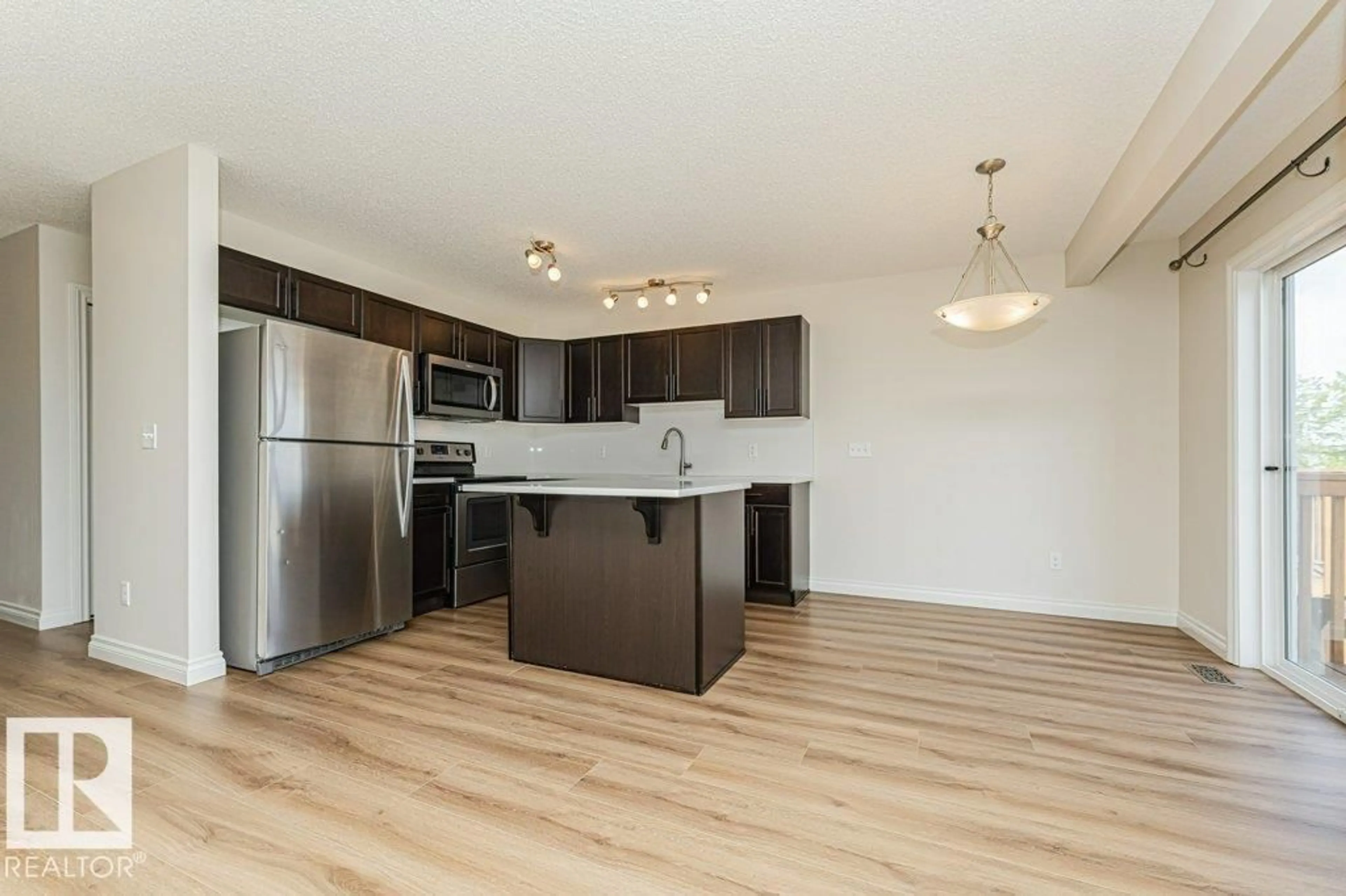 Open concept kitchen, wood/laminate floor for 445 - 32 BRINTNELL BV, Edmonton Alberta T5Y0V5
