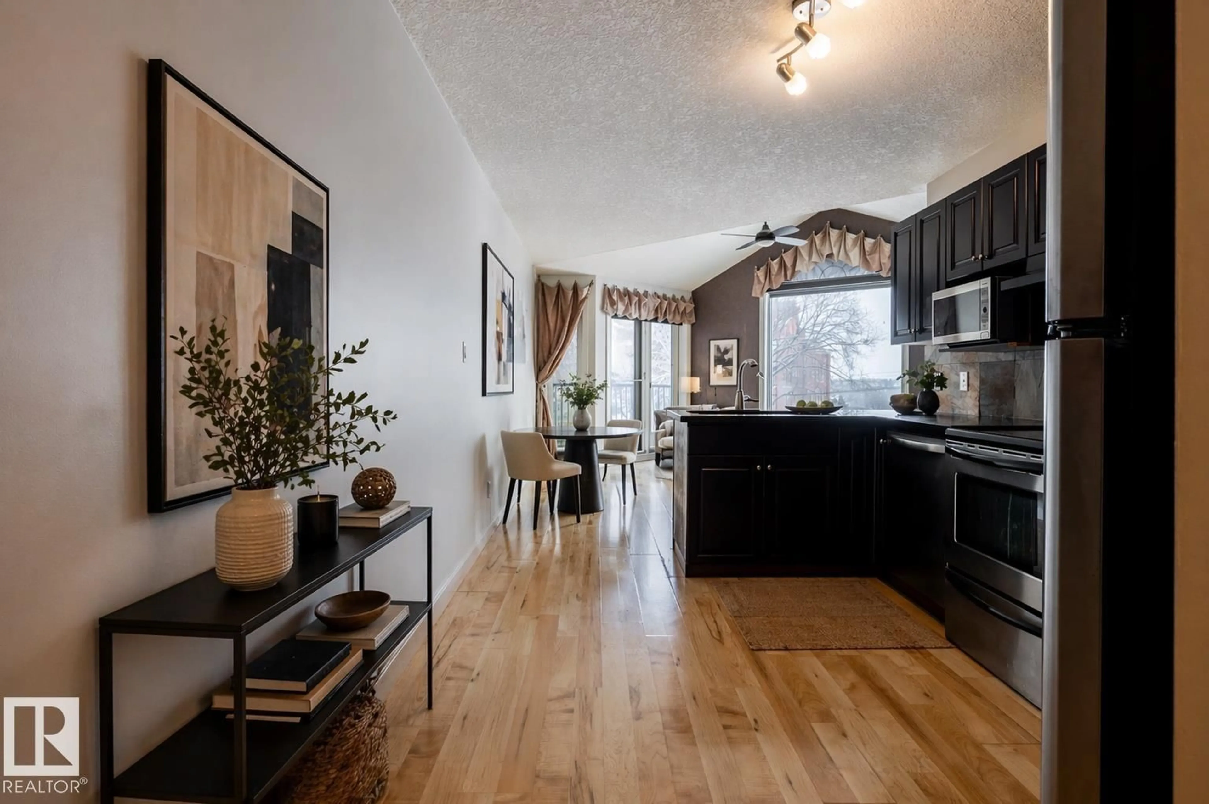 Open concept kitchen, wood/laminate floor for 304 - 9336 JASPER AV, Edmonton Alberta T5H3T5
