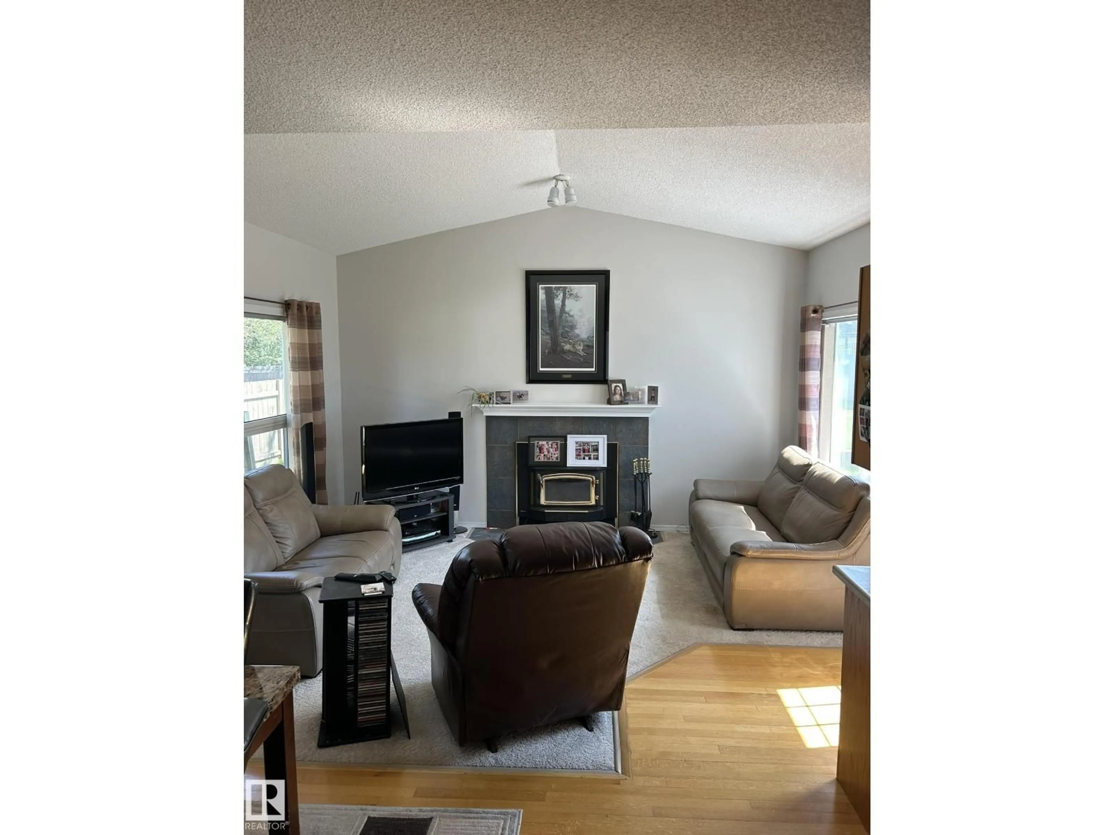 Living room with furniture, wood/laminate floor for 4014 CHAMPAGNE DR, Athabasca Town Alberta T9S1J2