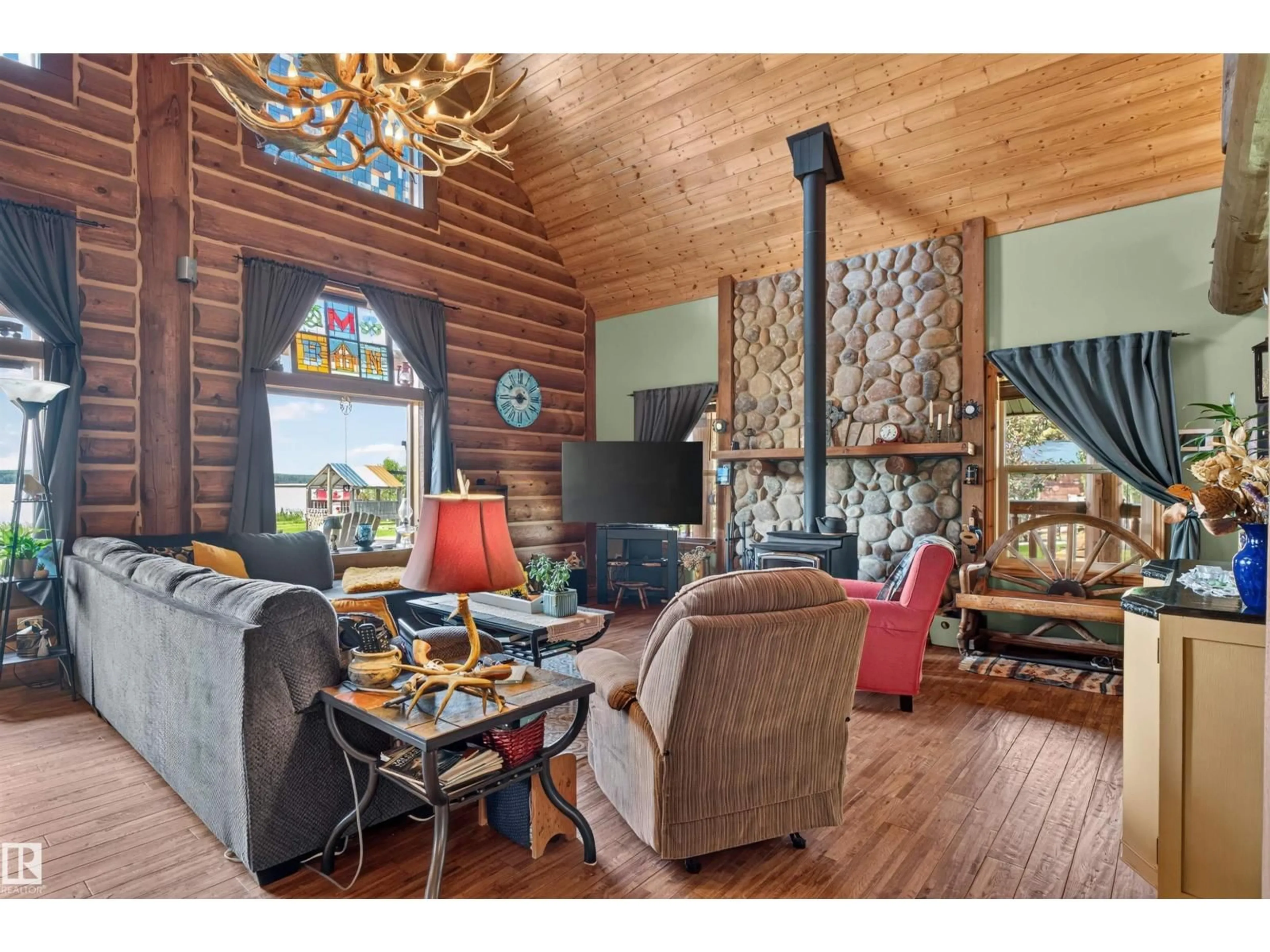 Living room with furniture, wood/laminate floor for 107 IDLEHOURS DRIVE, Rural Barrhead County Alberta T0G1A0