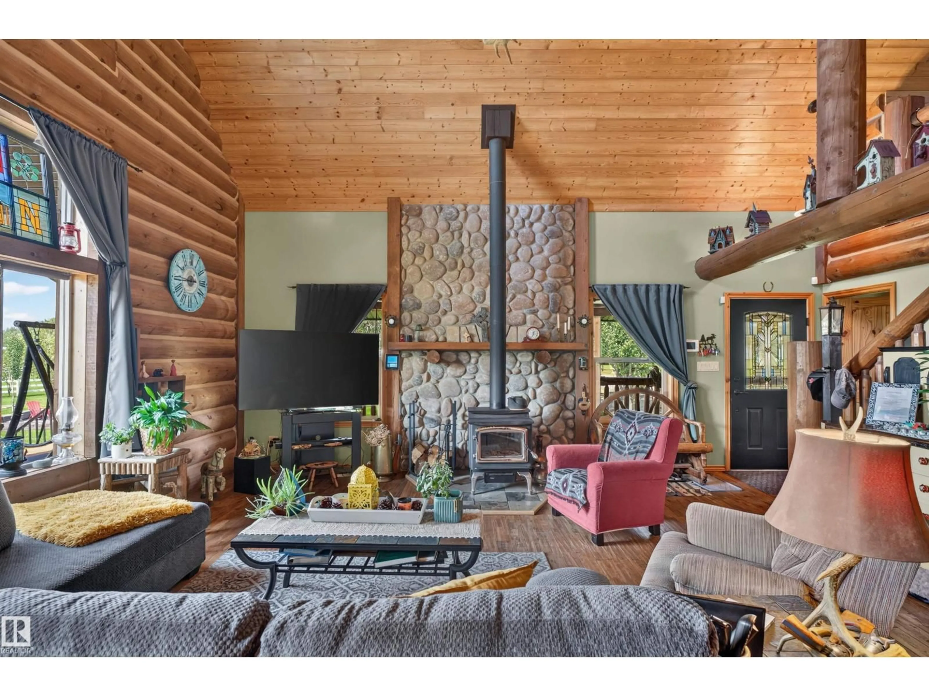 Living room with furniture, wood/laminate floor for 107 IDLEHOURS DRIVE, Rural Barrhead County Alberta T0G1A0