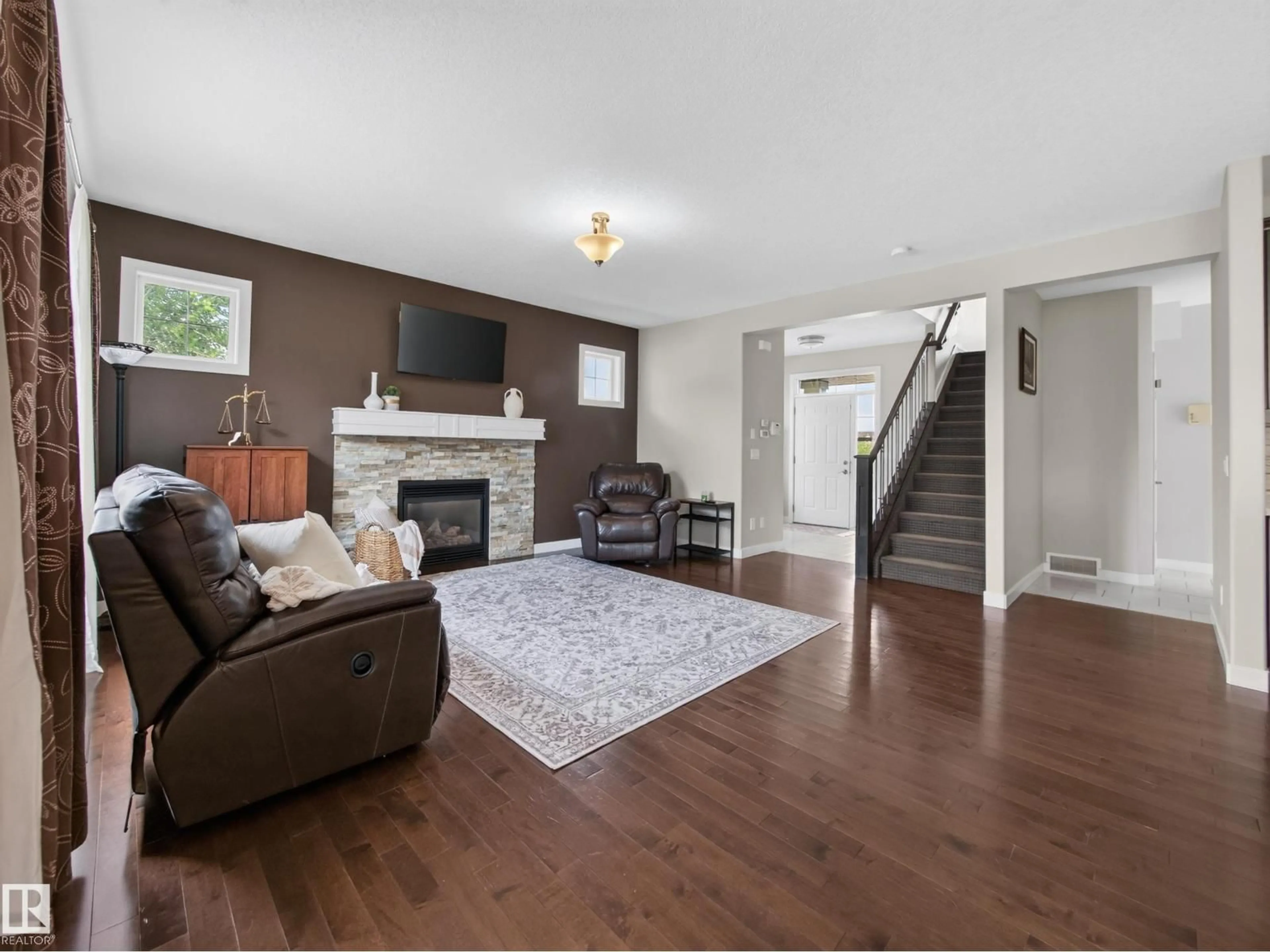Living room with furniture, wood/laminate floor for 5718 42 ST, Beaumont Alberta T4X0C2