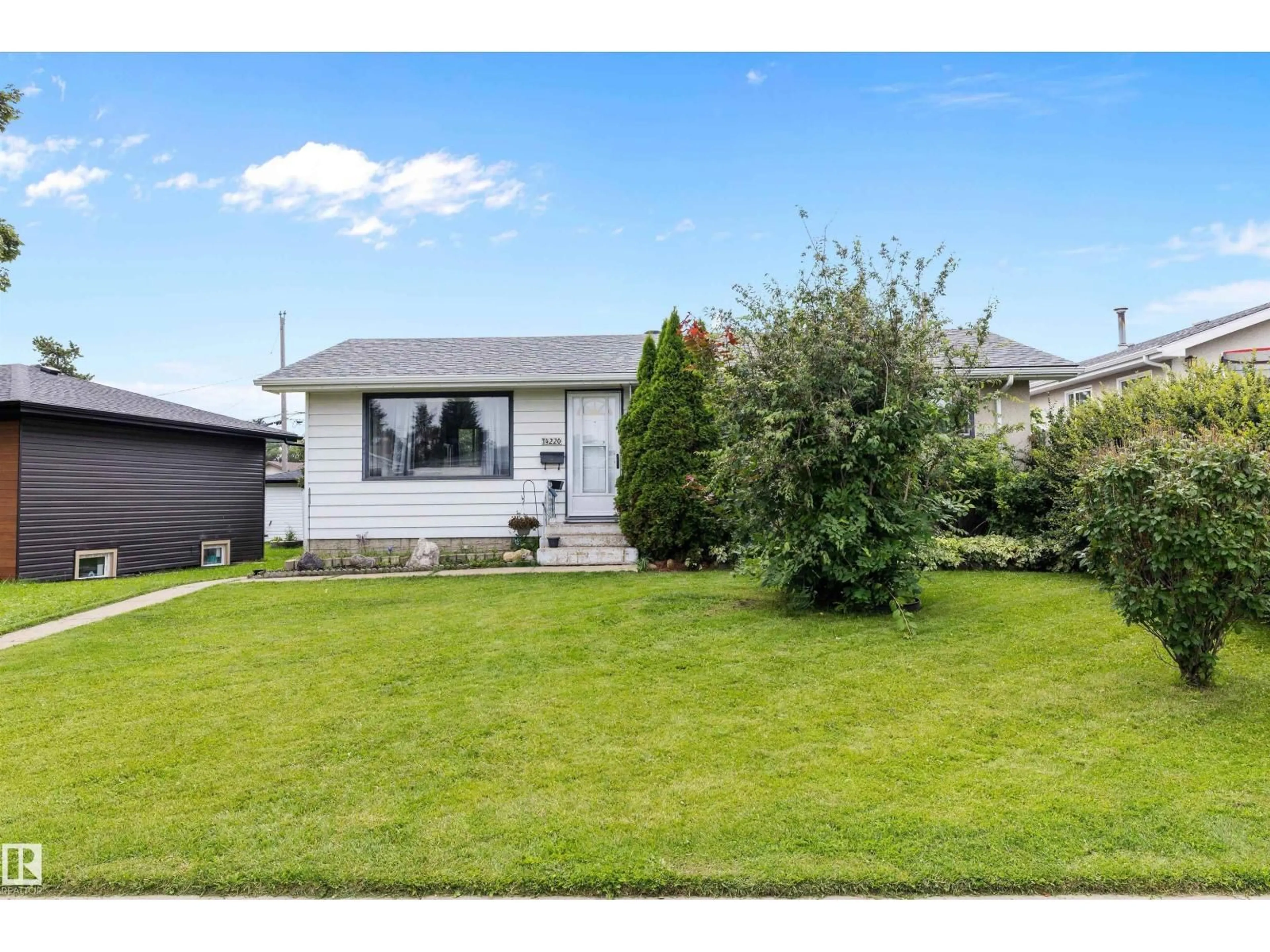 Home with vinyl exterior material, street for 14220 58 ST, Edmonton Alberta T5A1N4