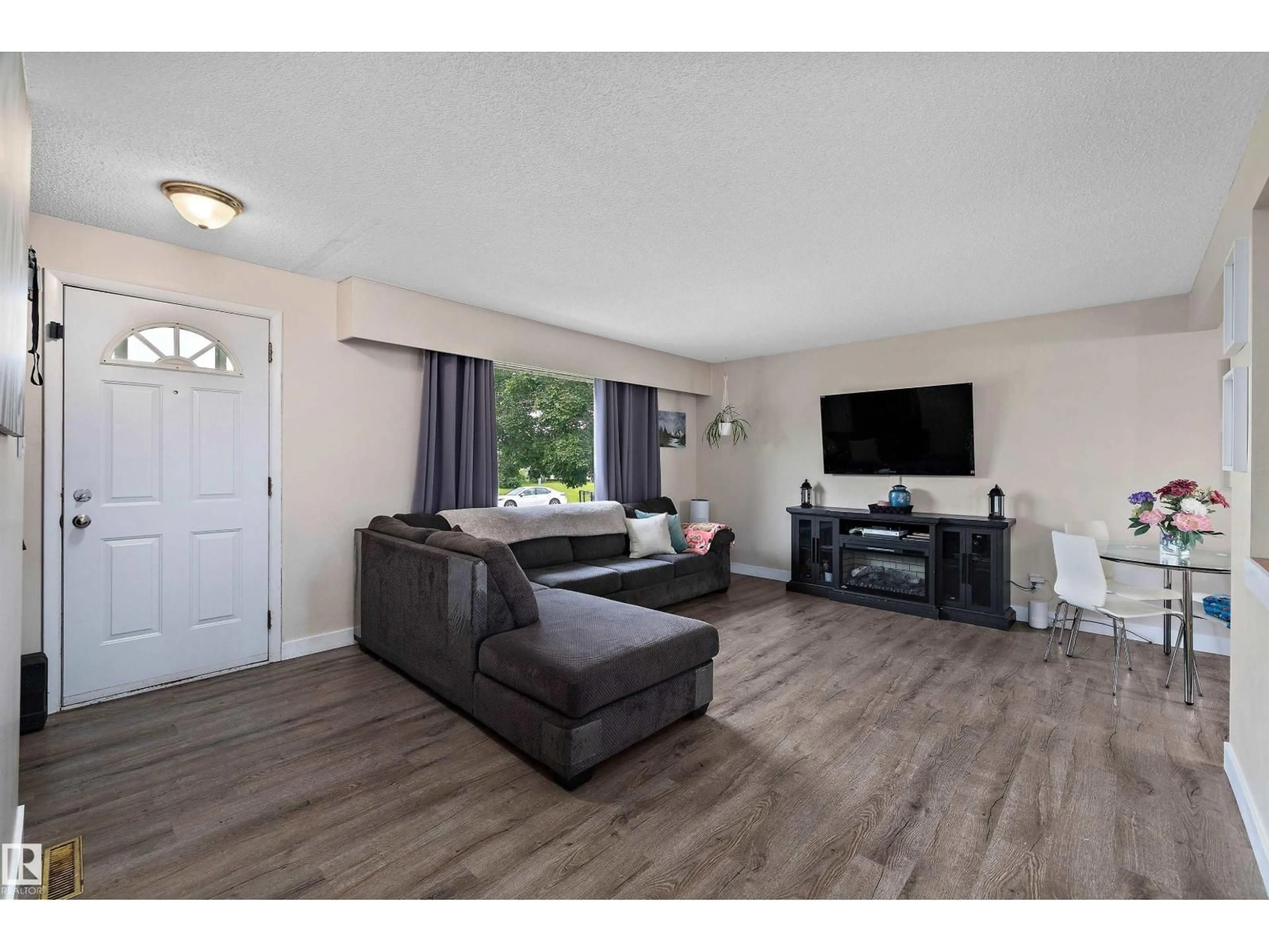 Living room with furniture, wood/laminate floor for 14220 58 ST, Edmonton Alberta T5A1N4