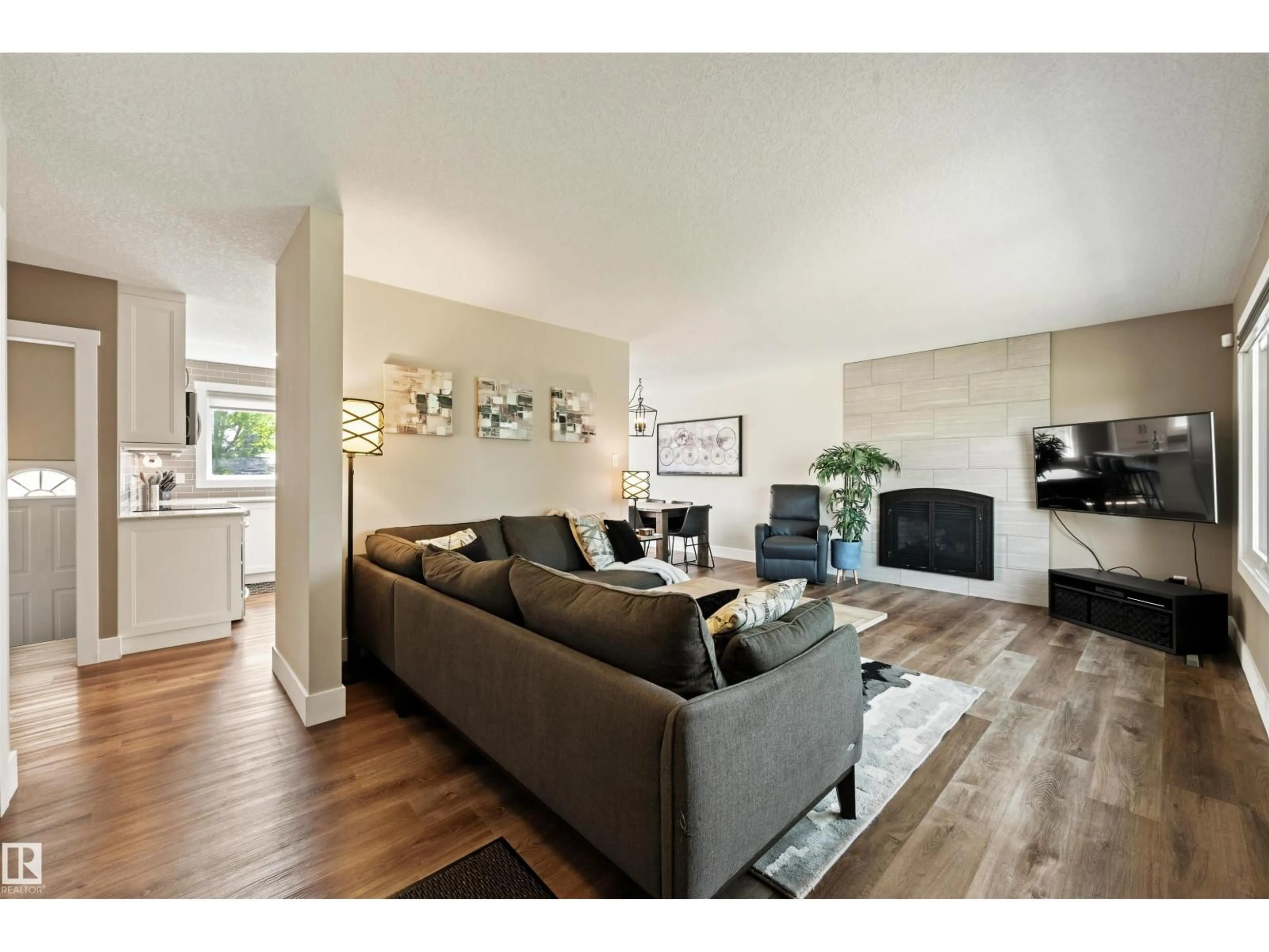 Living room with furniture, wood/laminate floor for NW - 5207 114B ST, Edmonton Alberta T6H3N4