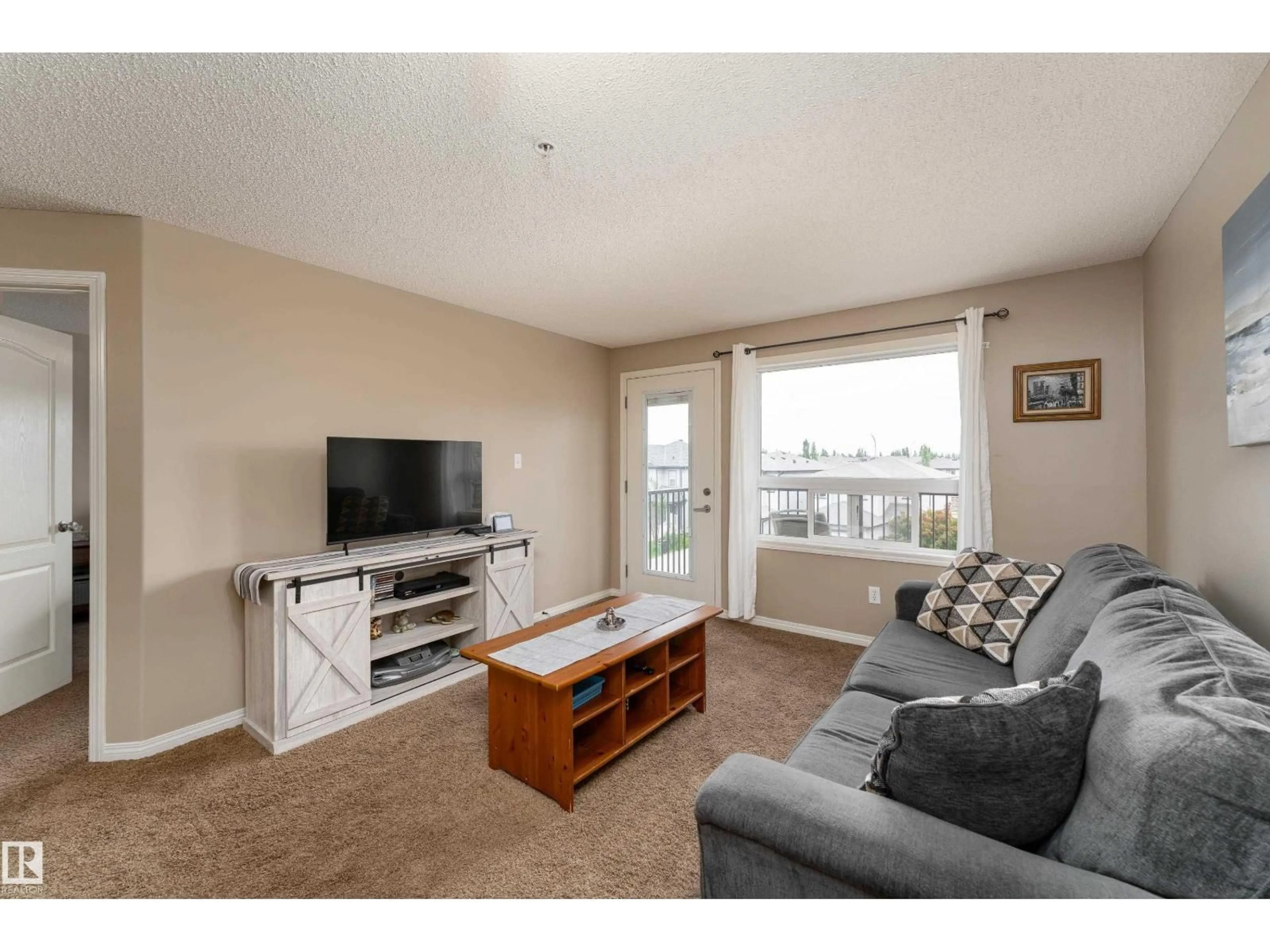 Living room with furniture, wood/laminate floor for #339 - 1520 HAMMOND GA, Edmonton Alberta T6M0J4
