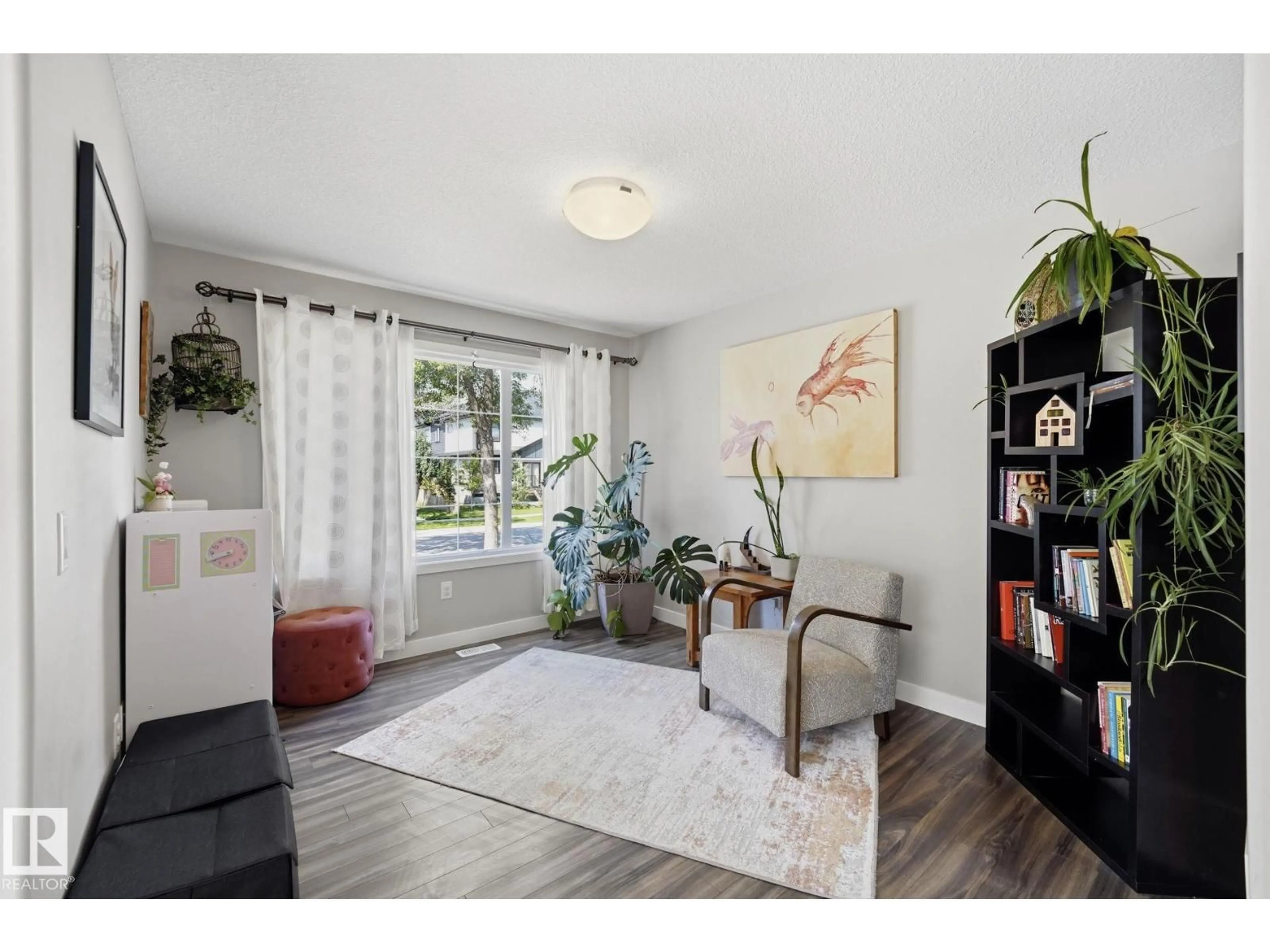 Living room with furniture, wood/laminate floor for NW - 10245 152 ST, Edmonton Alberta T5P1Y3