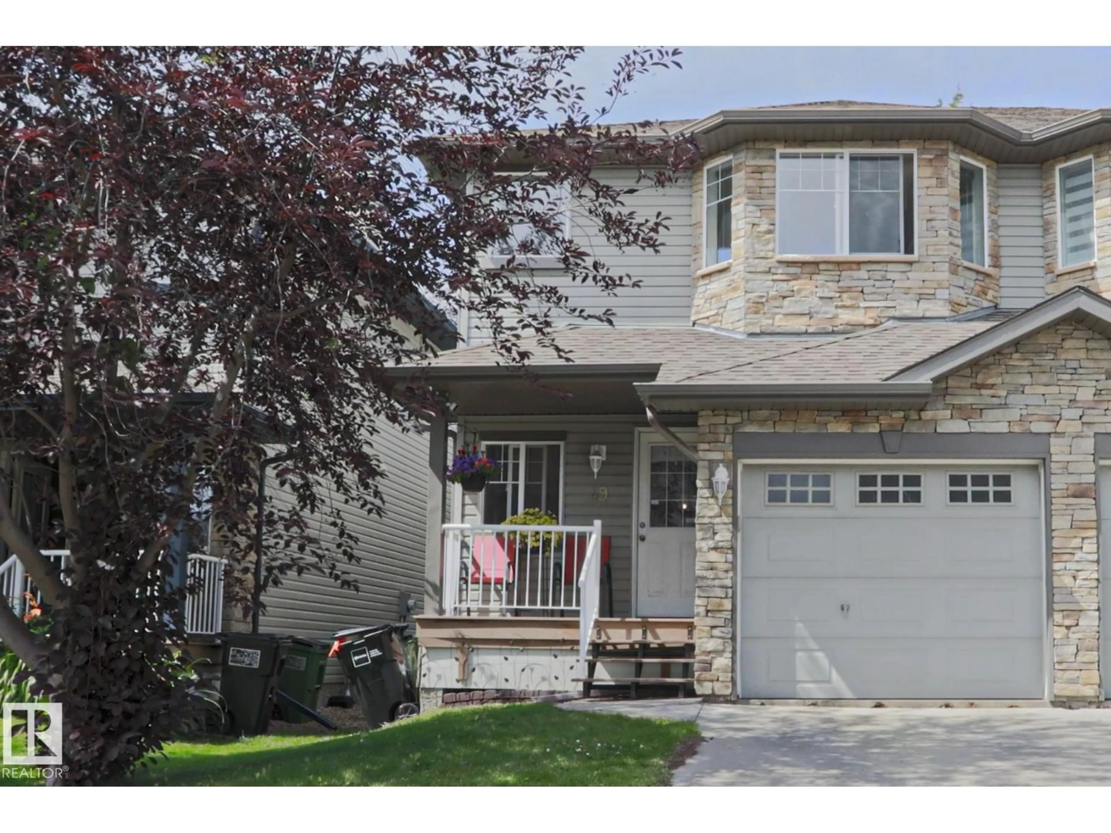 Home with vinyl exterior material, street for 6304 - 49 SANDIN WY, Edmonton Alberta T6R0J8