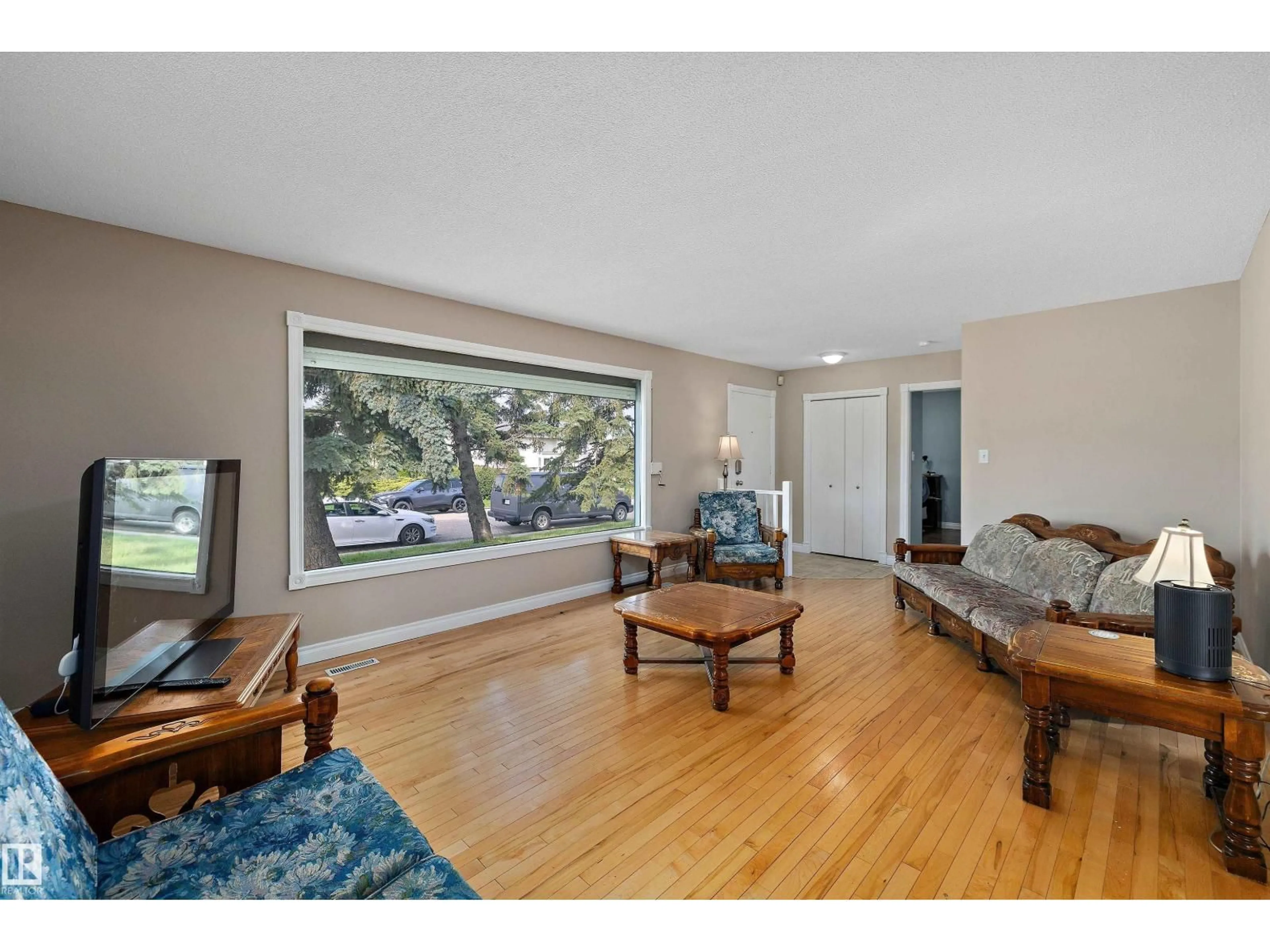 Living room with furniture, wood/laminate floor for 3511 73 ST, Edmonton Alberta T6K0M2