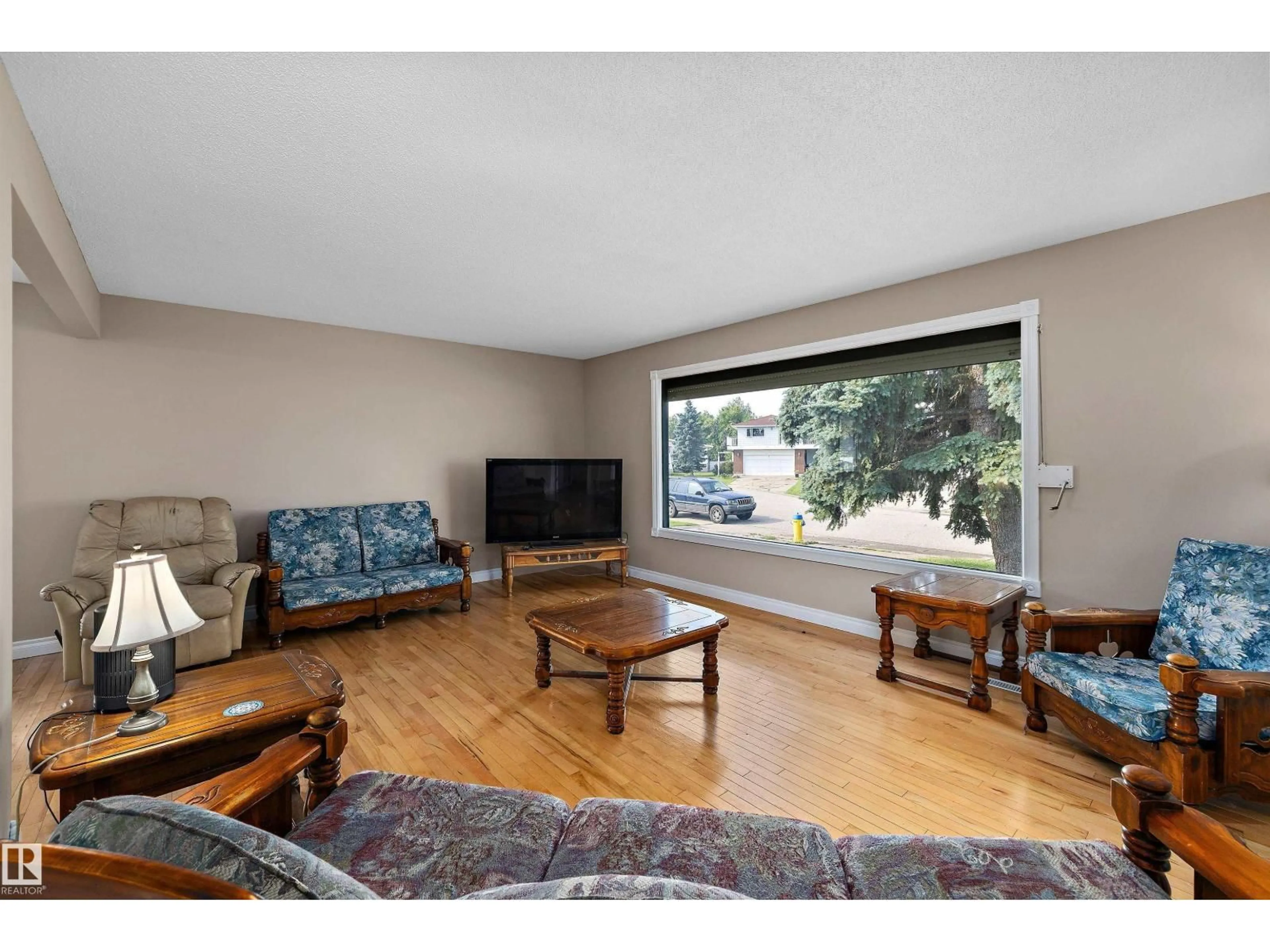 Living room with furniture, wood/laminate floor for 3511 73 ST, Edmonton Alberta T6K0M2