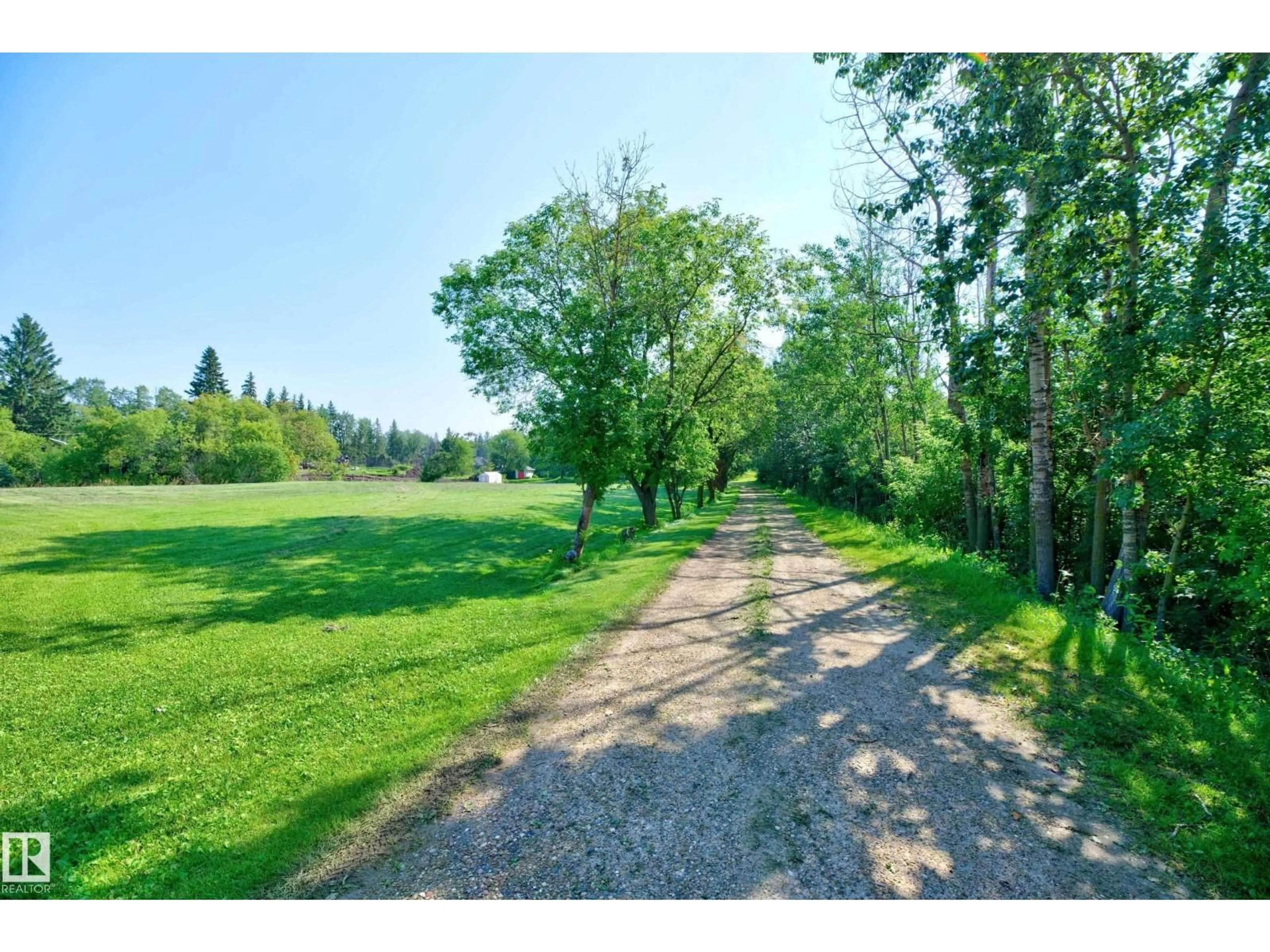 A pic from outside/outdoor area/front of a property/back of a property/a pic from drone, water/lake/river/ocean view for 22559 - 319 WYE RD, Rural Strathcona County Alberta T8C1H9
